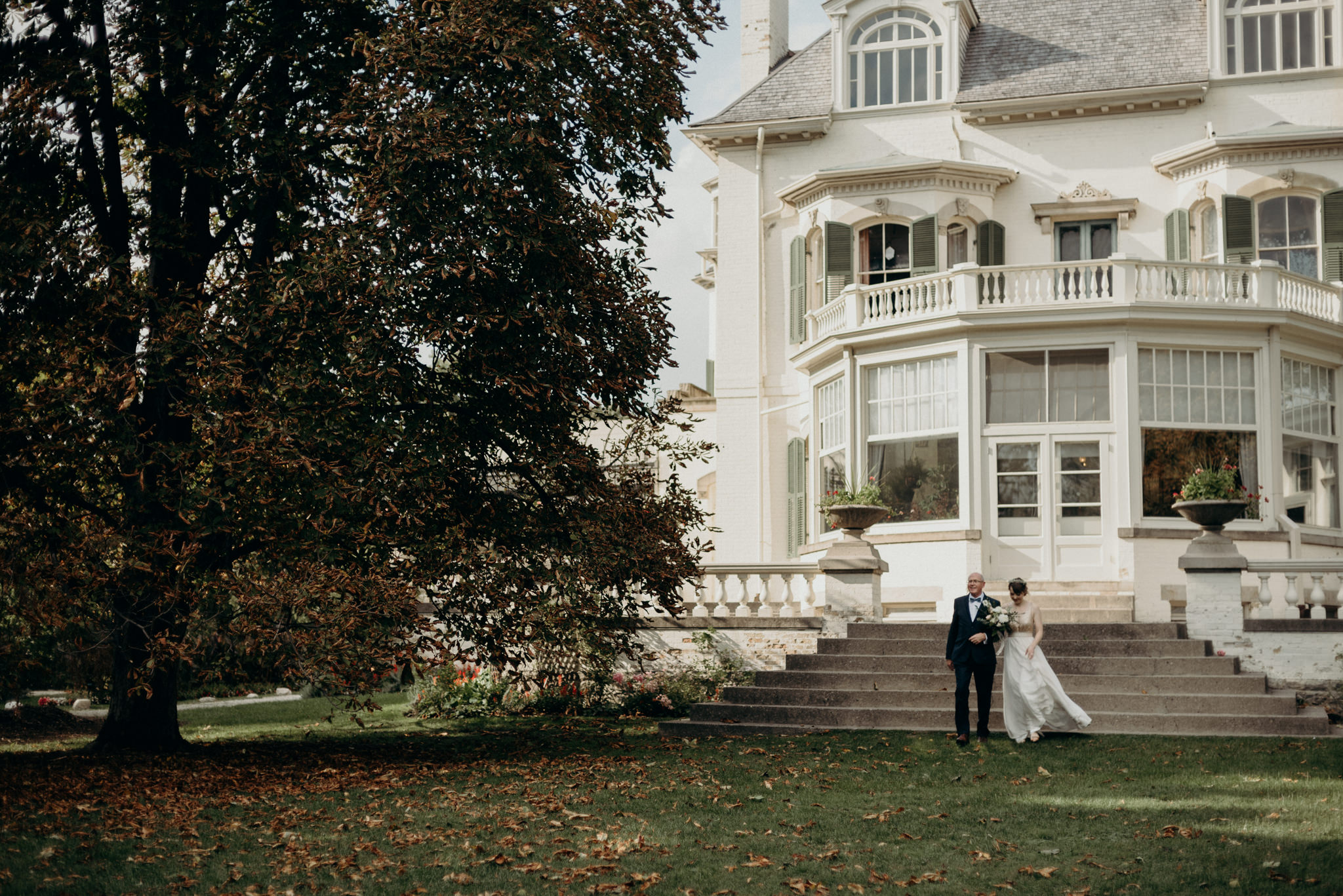 bride and father walking down stairs at Spadina Museum