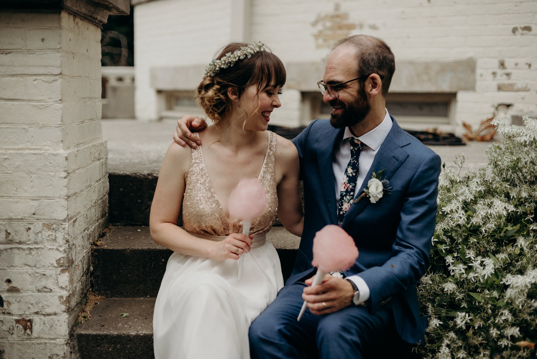 bride and groom sitting on steps of Spadina Museum with cotton candy