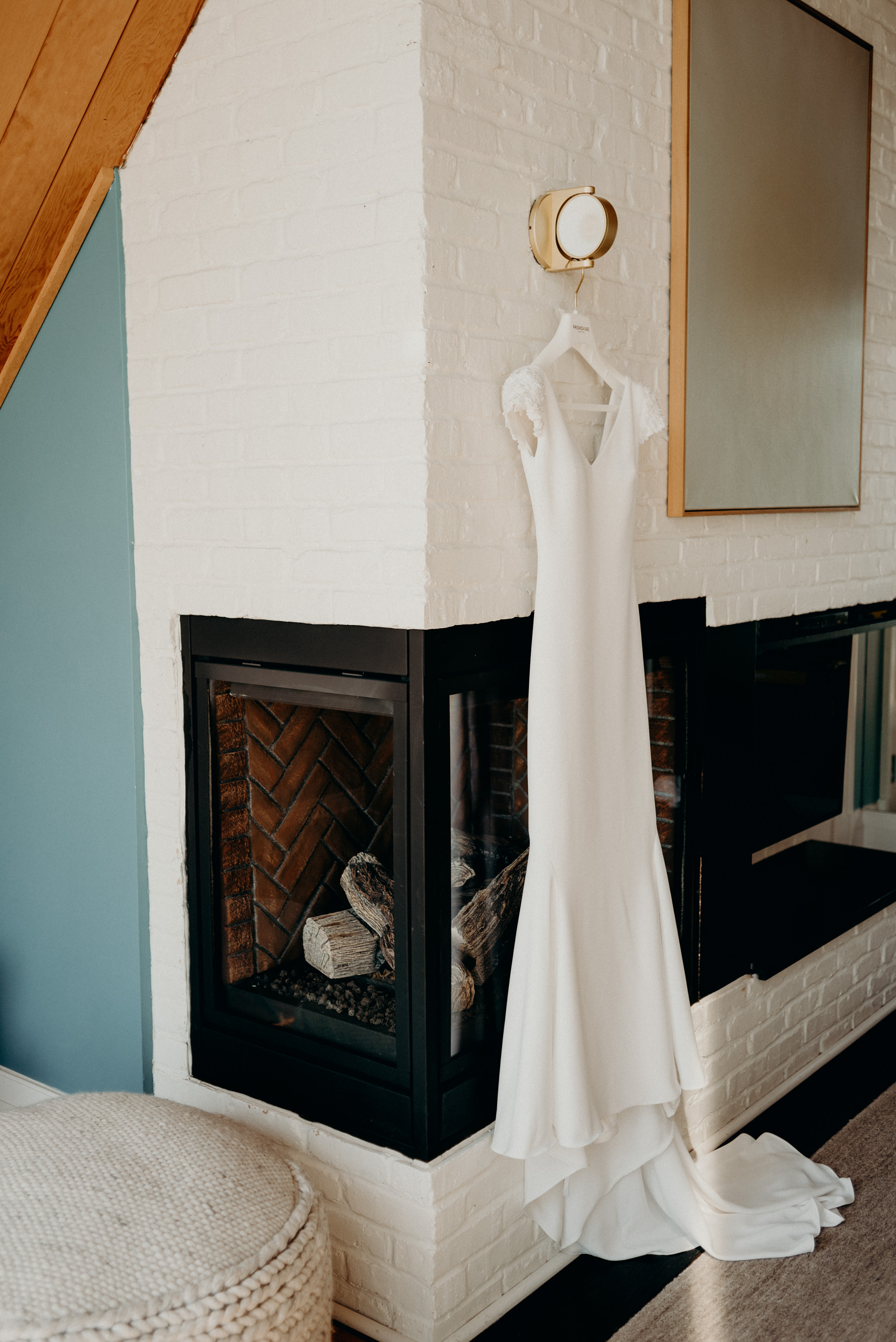 Pronovias wedding dressing hanging on white brick wall at Drake Devonshire