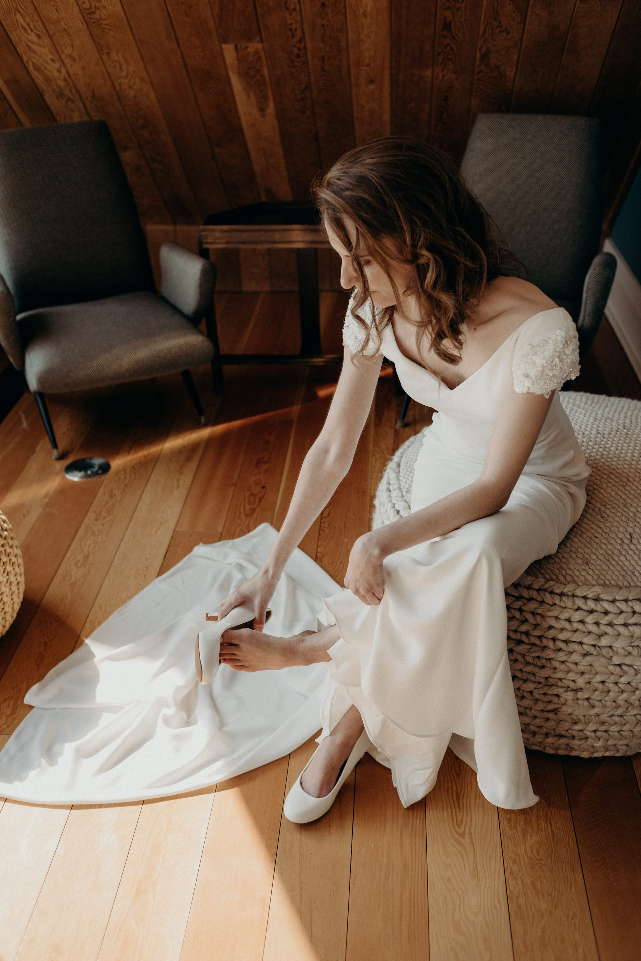 bride putting on wedding shoes