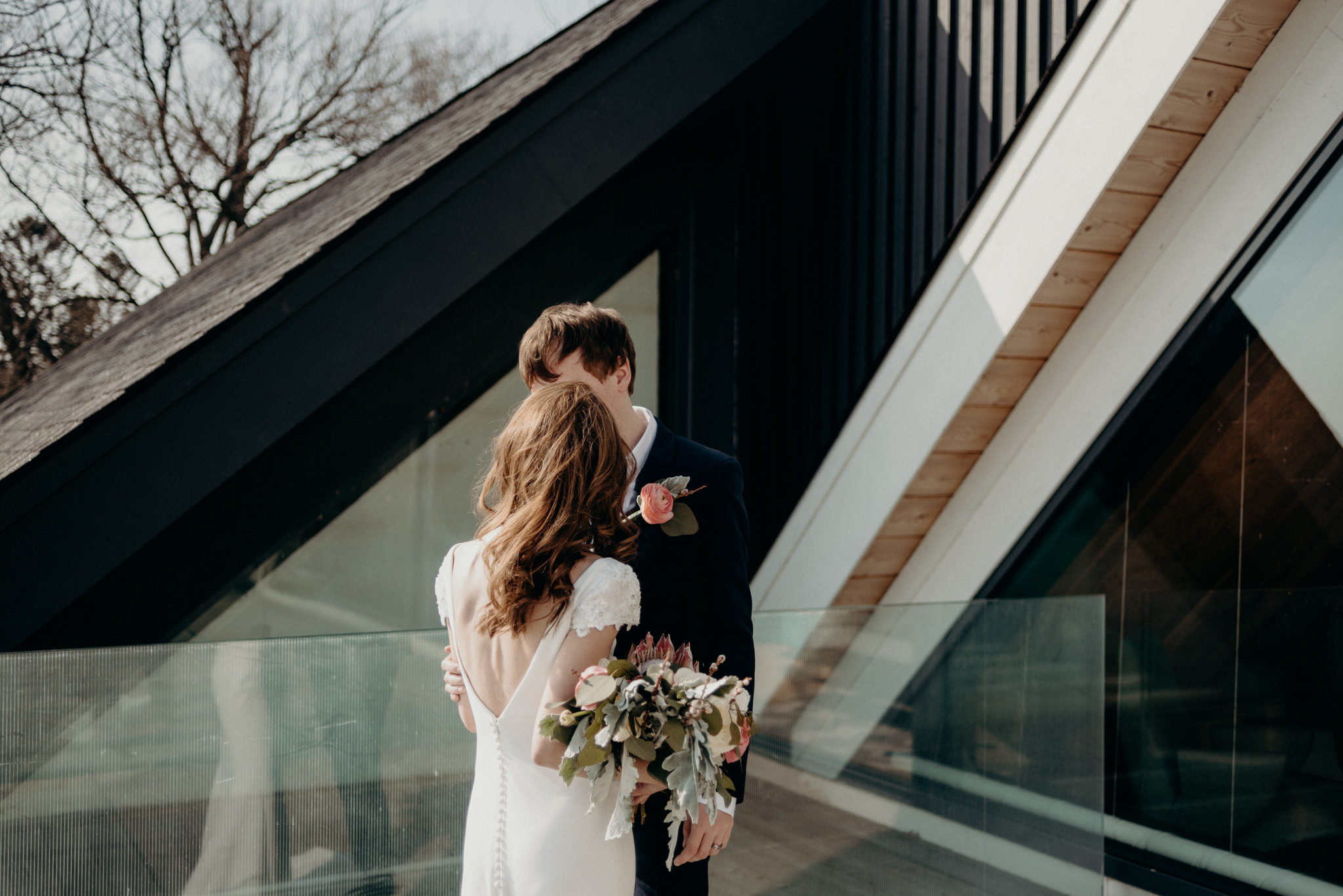 couple on patio in winter outside aframe cabin