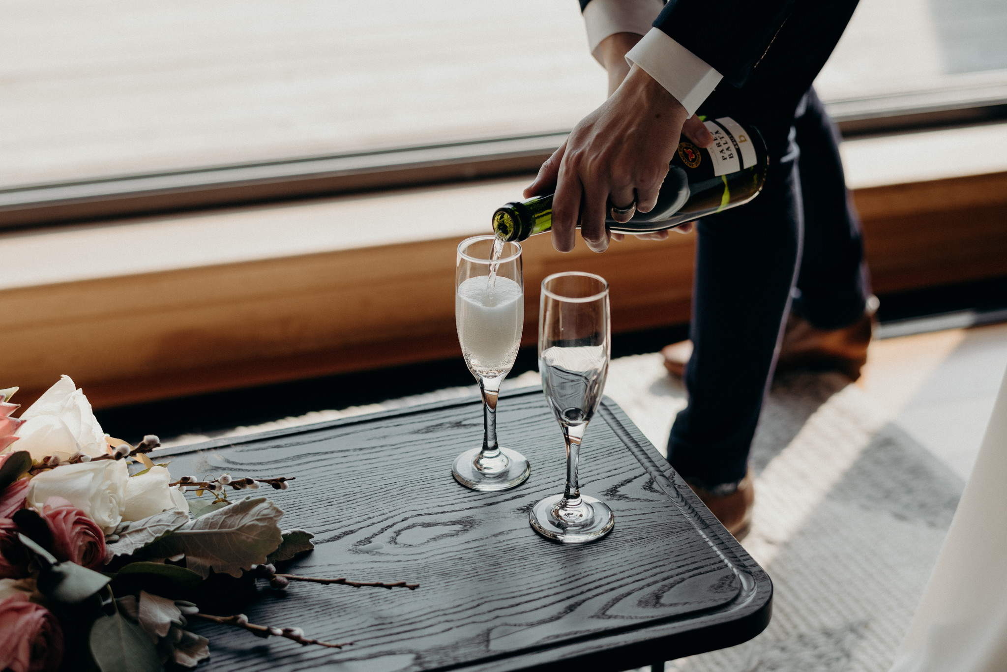 groom pouring champagne