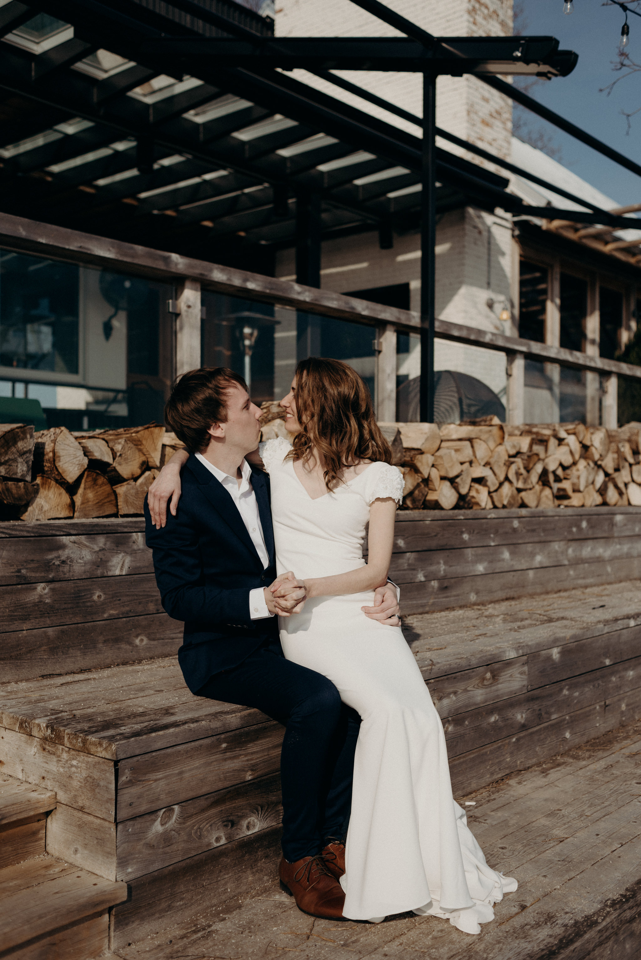 Couple sitting on patio for wedding portraits at Drake Devonshire in Wellington, Ontario