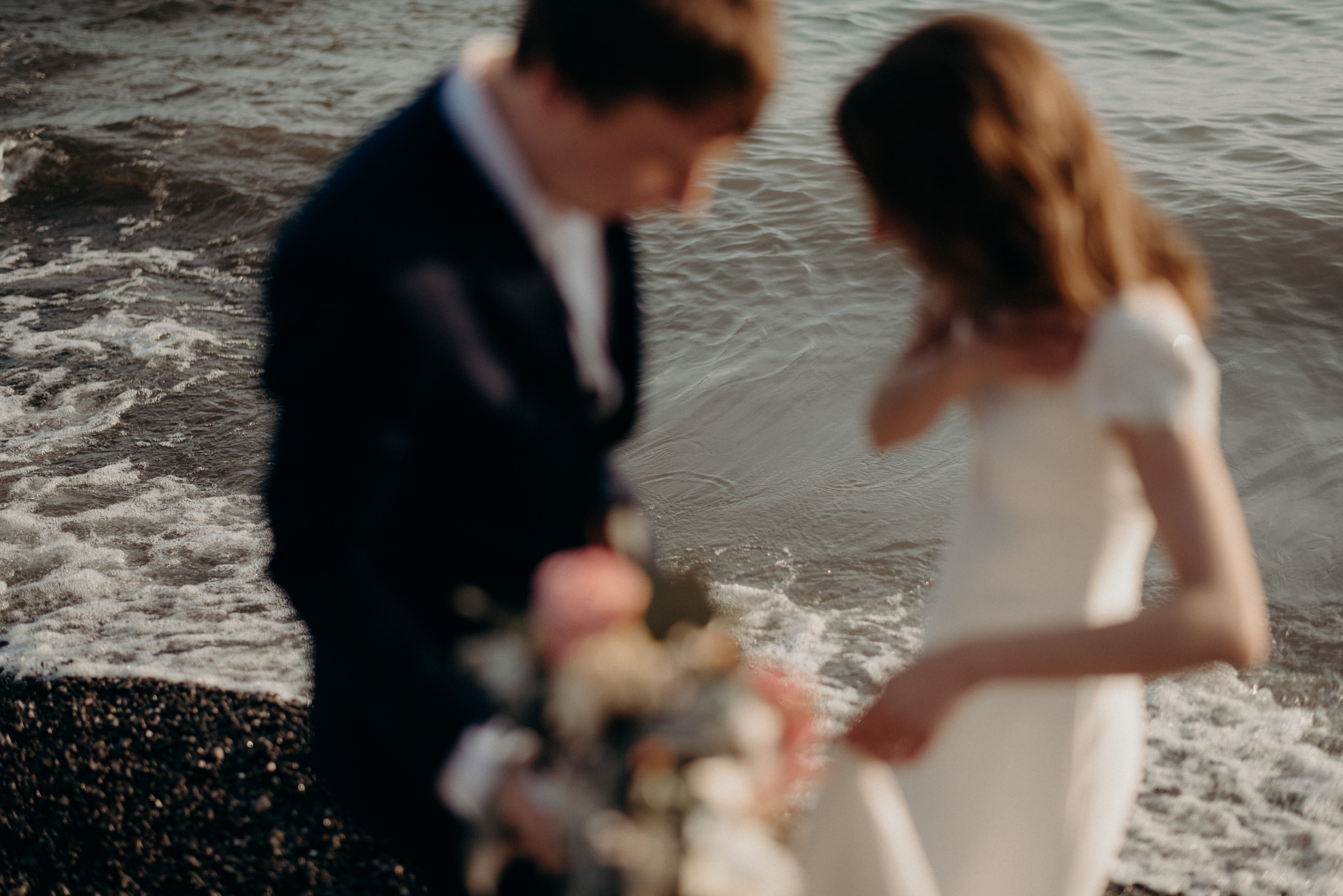 wedding couple out of focus and water in focus