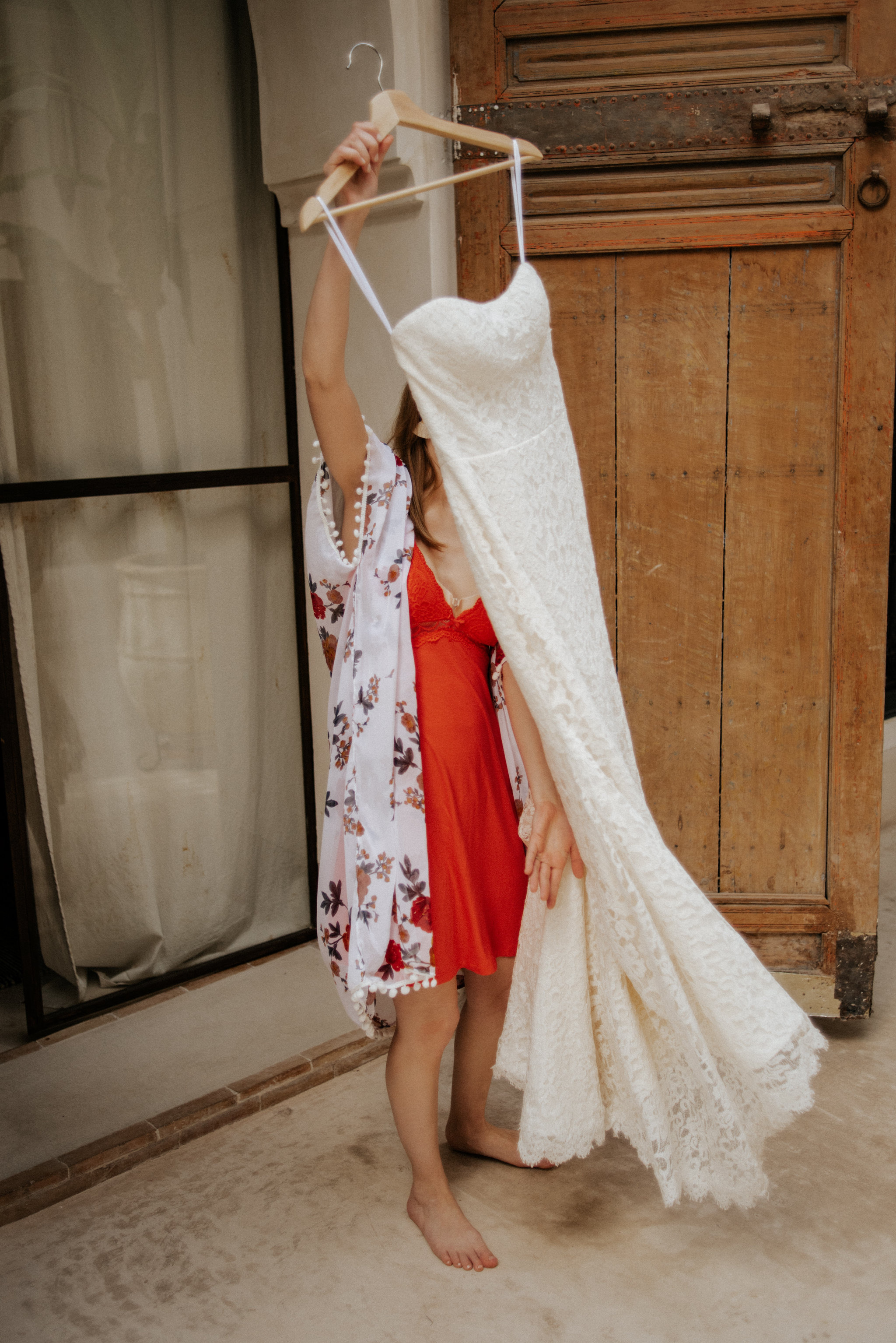 Bride holding dress, about to get ready for Morocco elopement