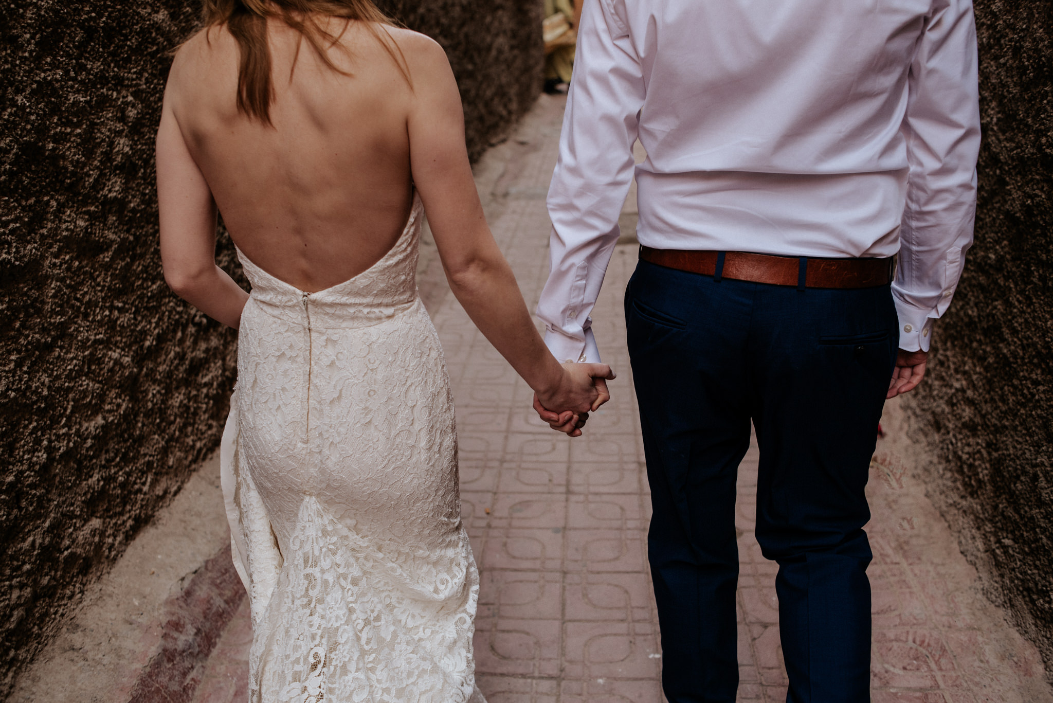 Bride and groom walking in the medina in Marrakech for their Morocco elopement