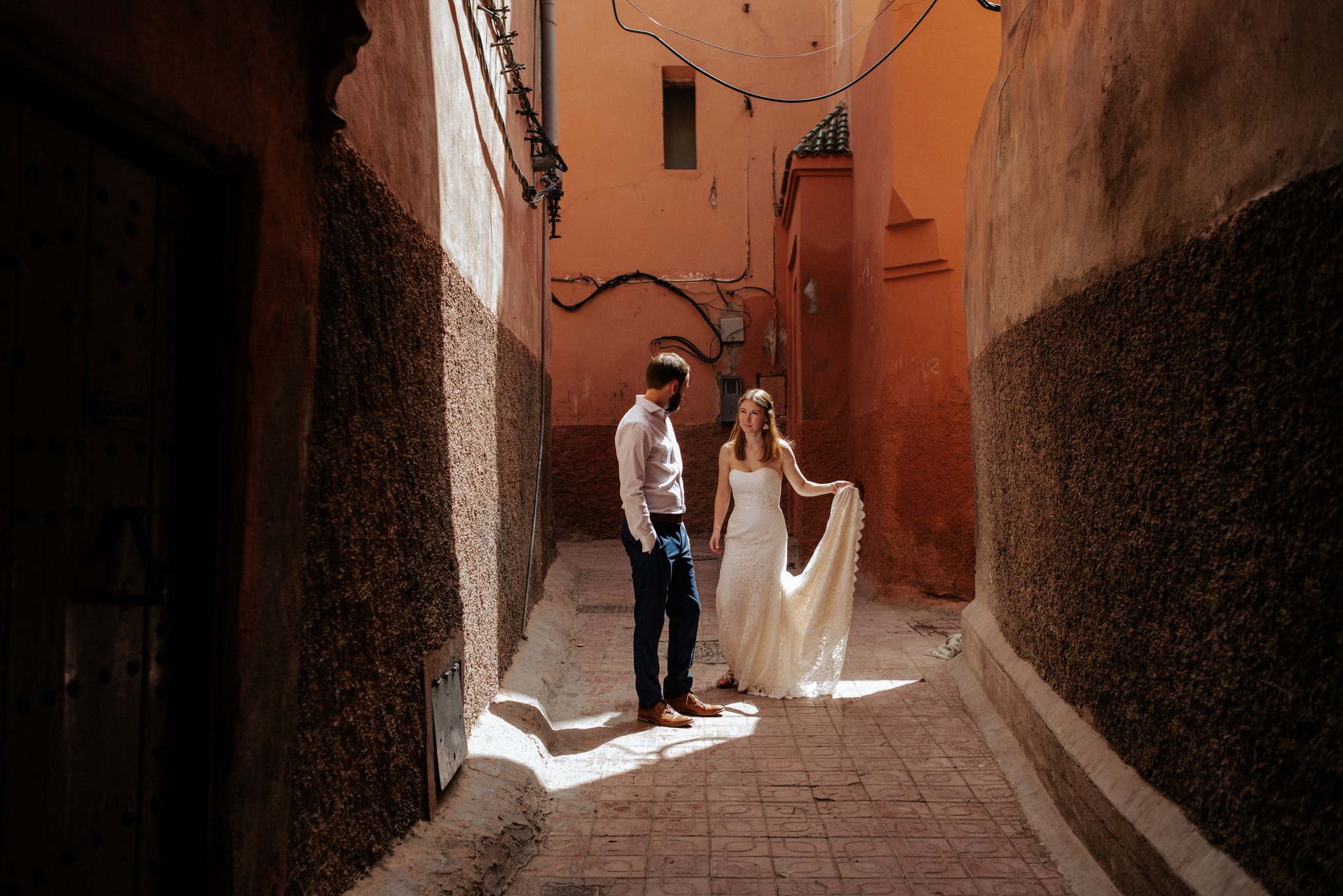 Bride and groom walking in the medina in Marrakech for their Morocco elopement