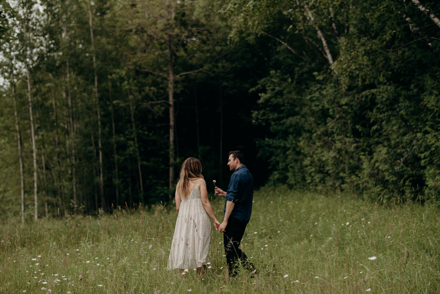 guy picks daisy flower for girl