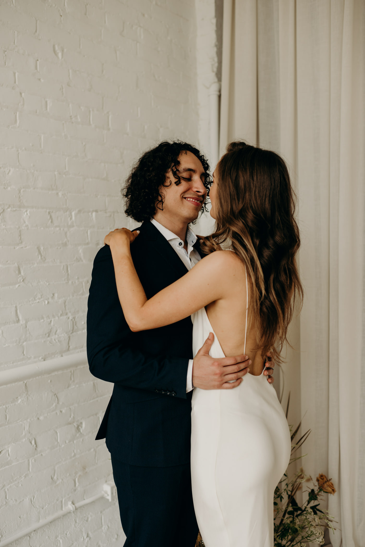 Bride in Savannah Miller wedding dress in bohemian loft in Toronto