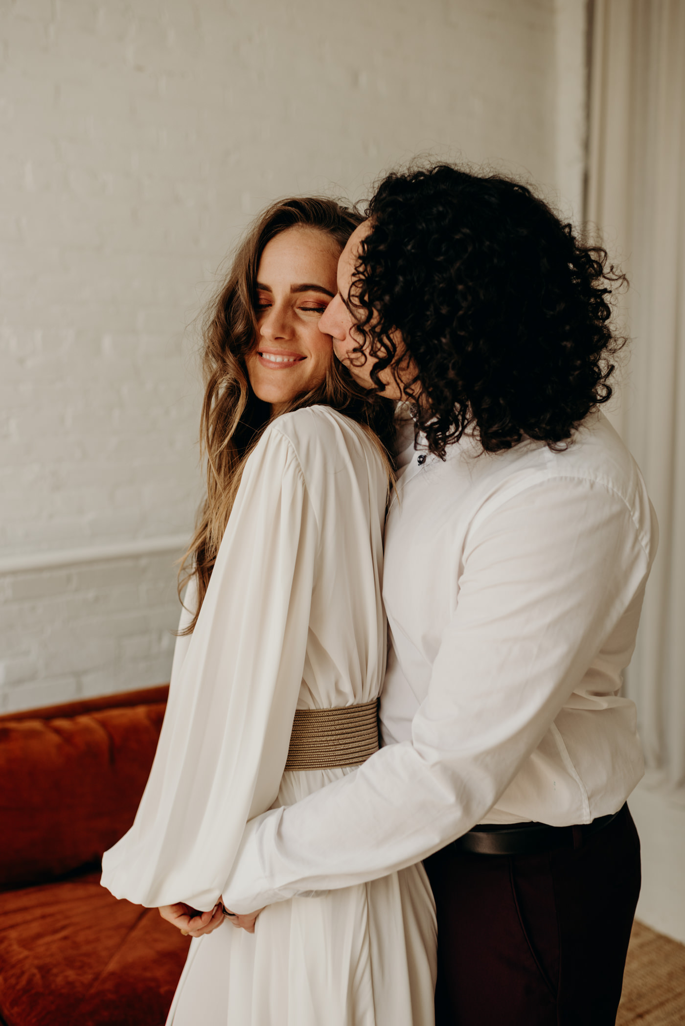 groom kissing bride on cheek