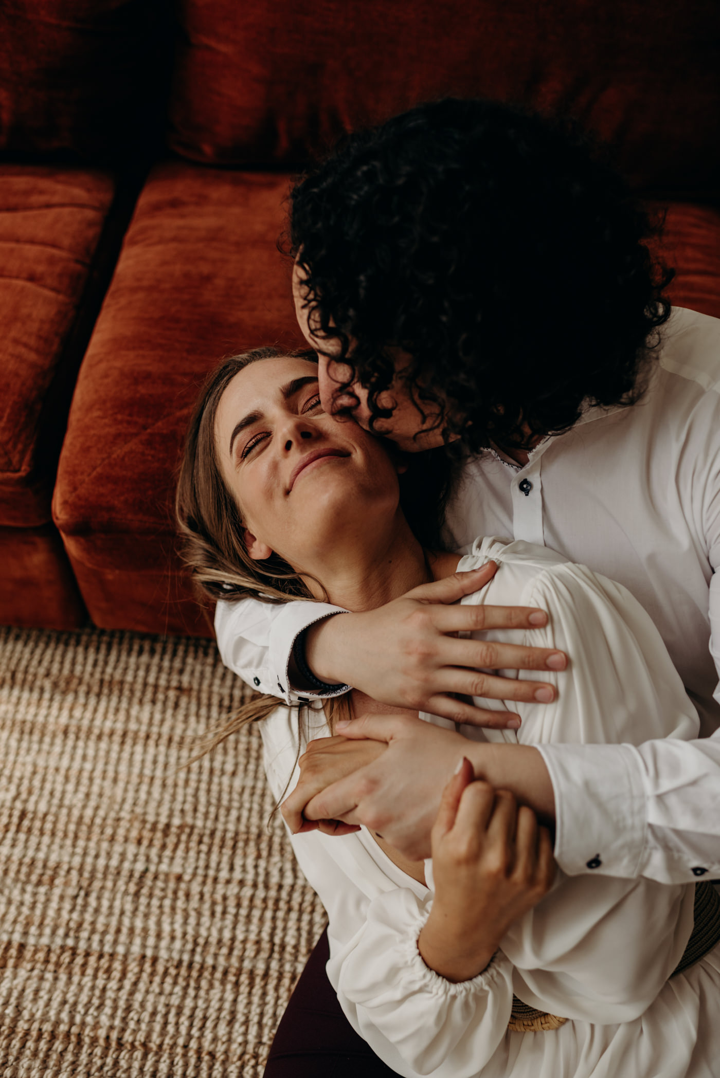 midcentury loft elopement, couple cuddling and sitting on ground of loft