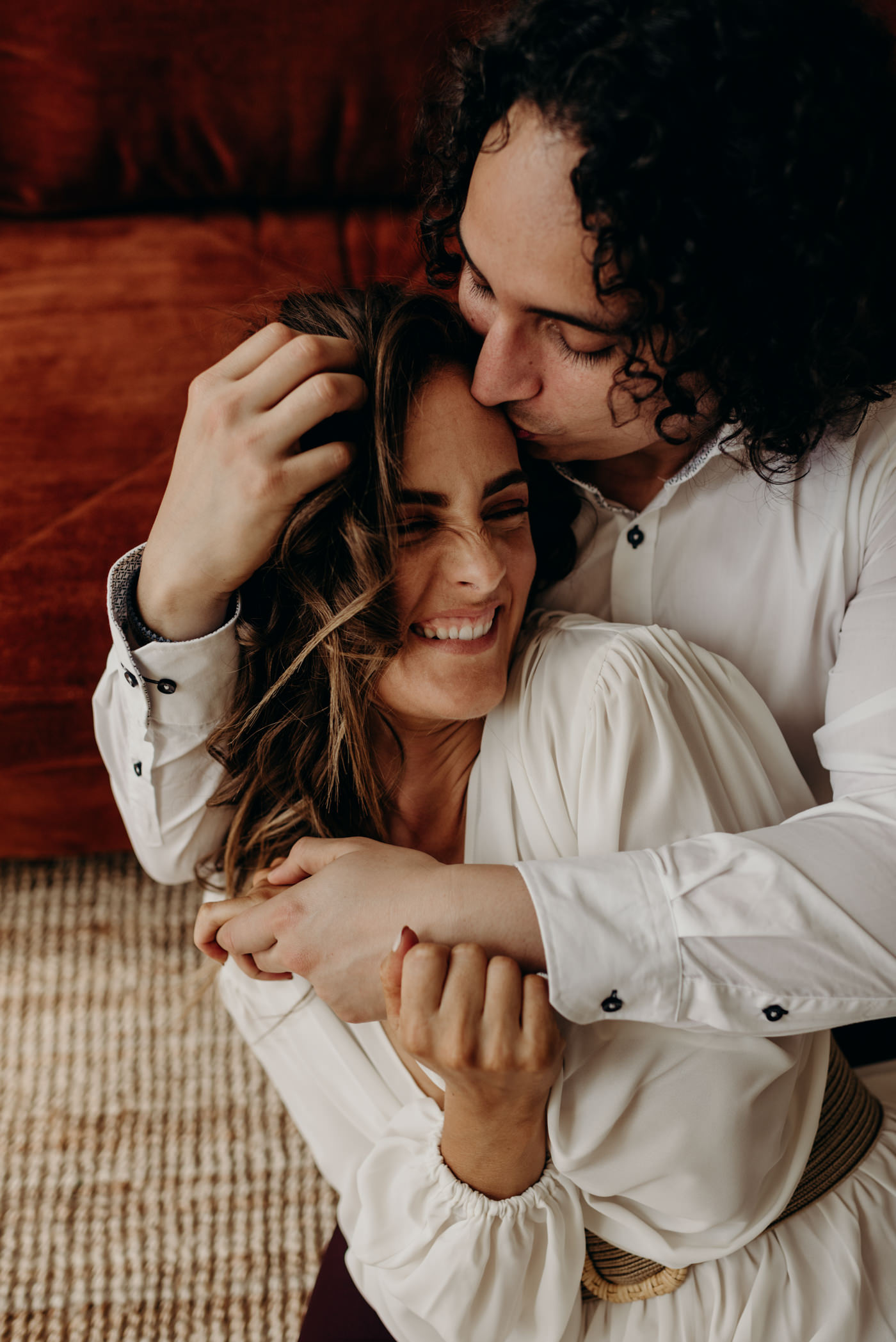 groom kissing bride on forehead