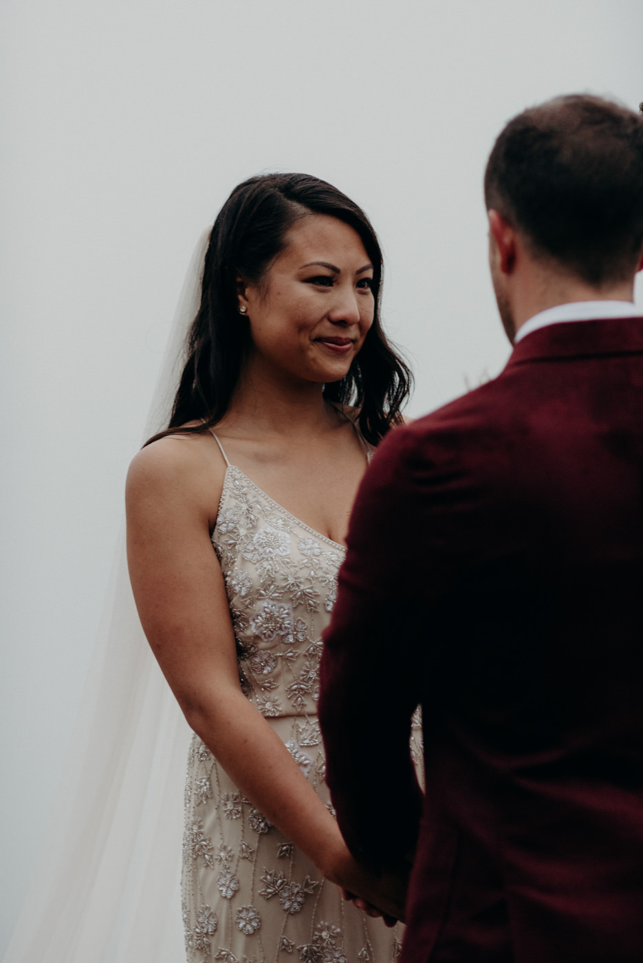 bride crying while groom reads vows