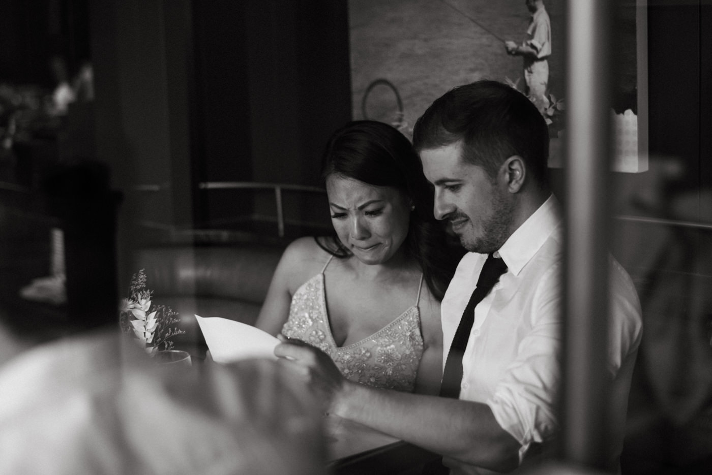 emotional bride crying as they read letters from family on their wedding day
