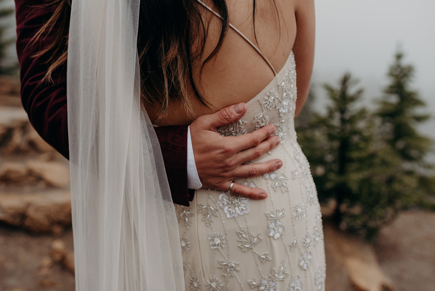 groom hand around brides waist