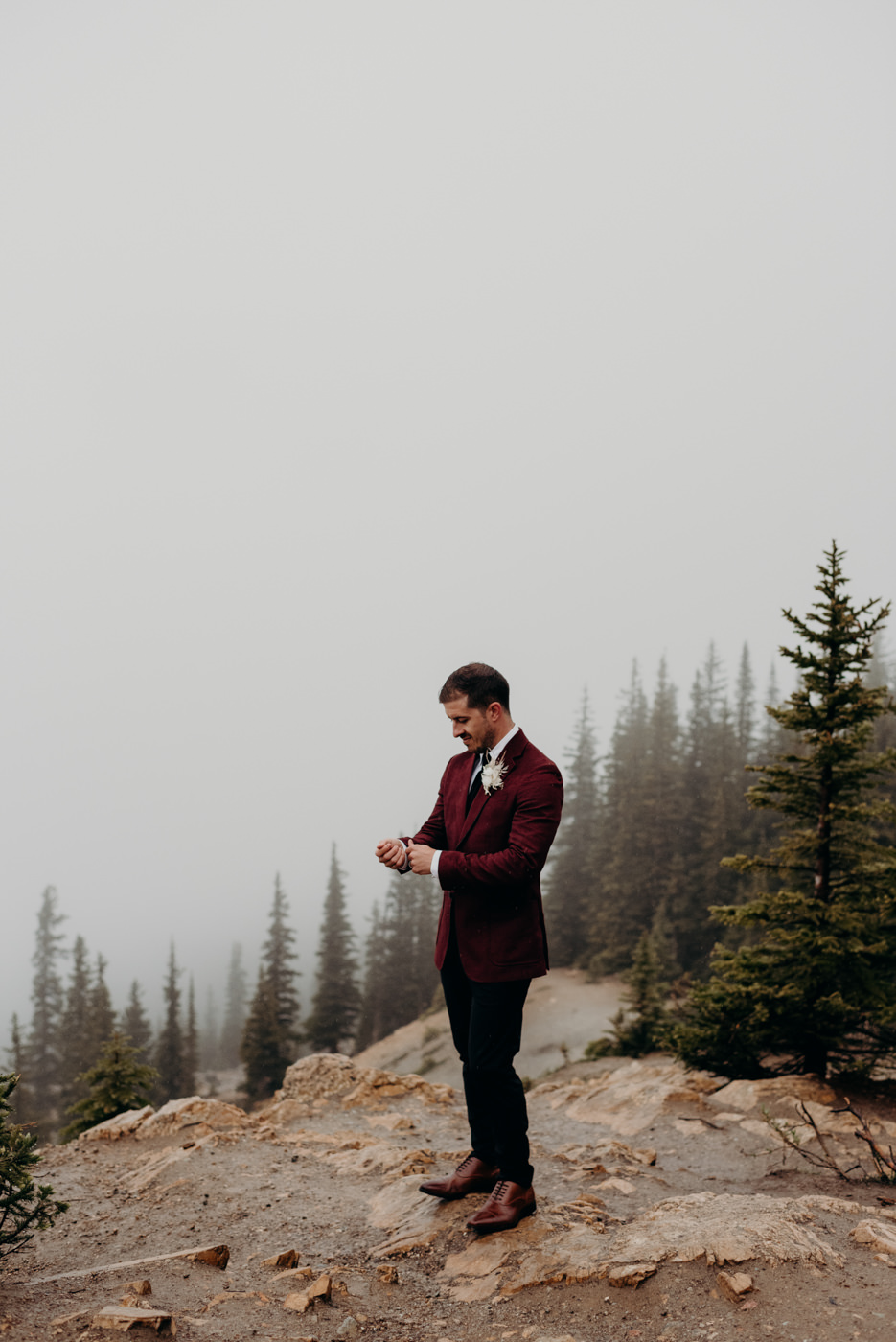 Groom standing on mountain edge, Banff National Park elopement