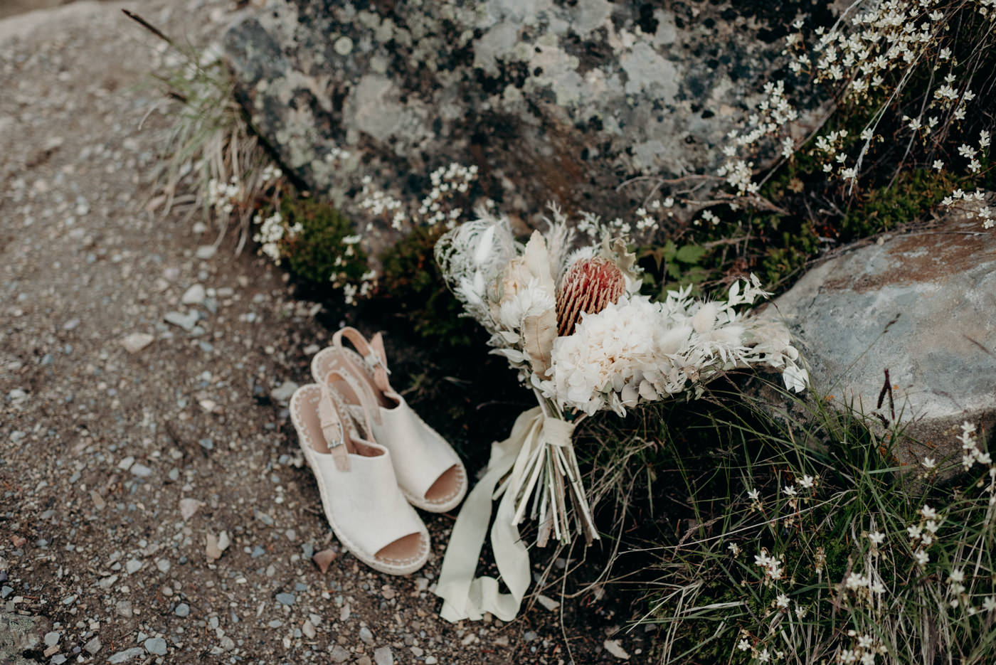 shoes and bouquet on the ground
