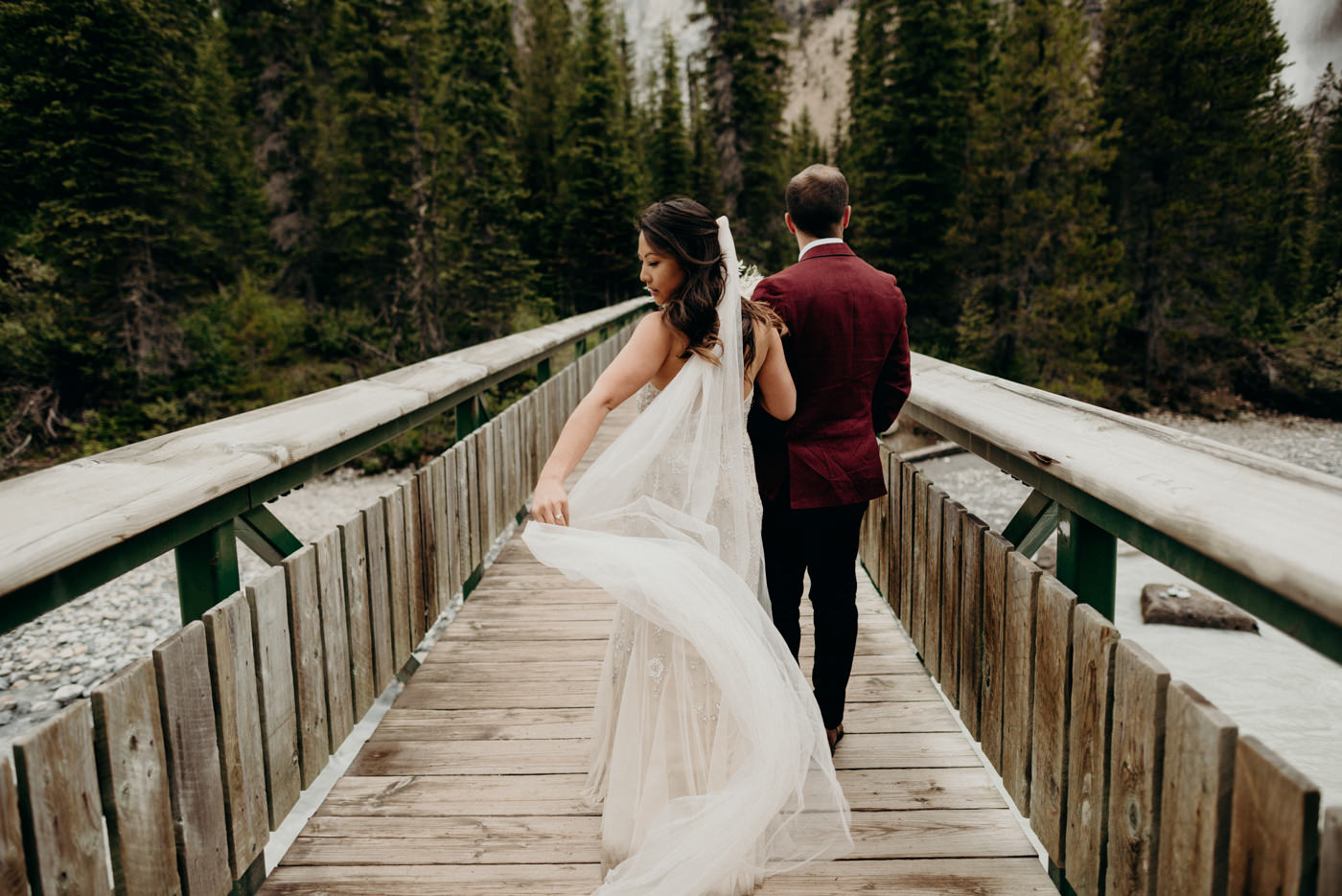 brides veil flowing in the wind as they walk