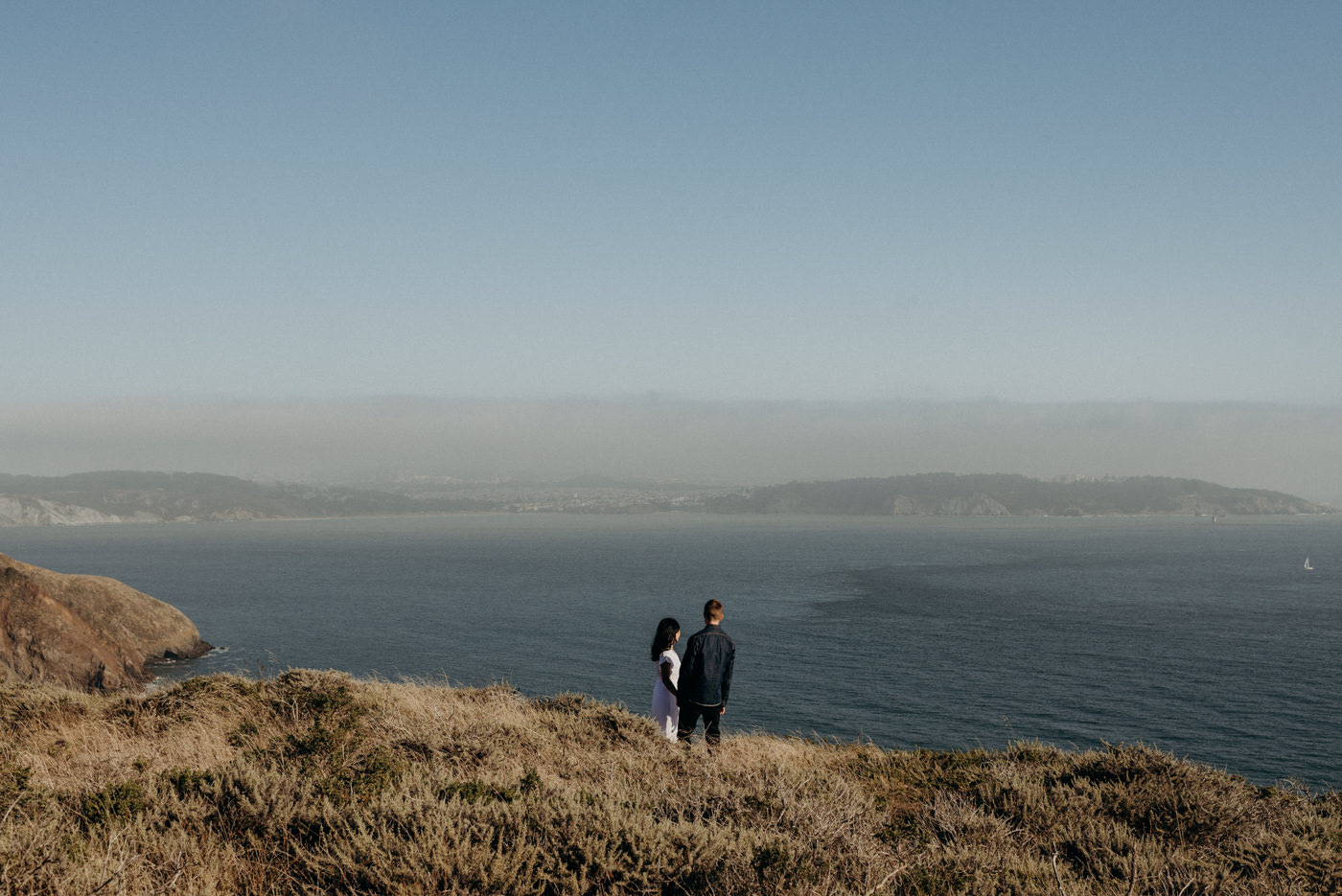 Couple looking off to ocean at Marin Headlands