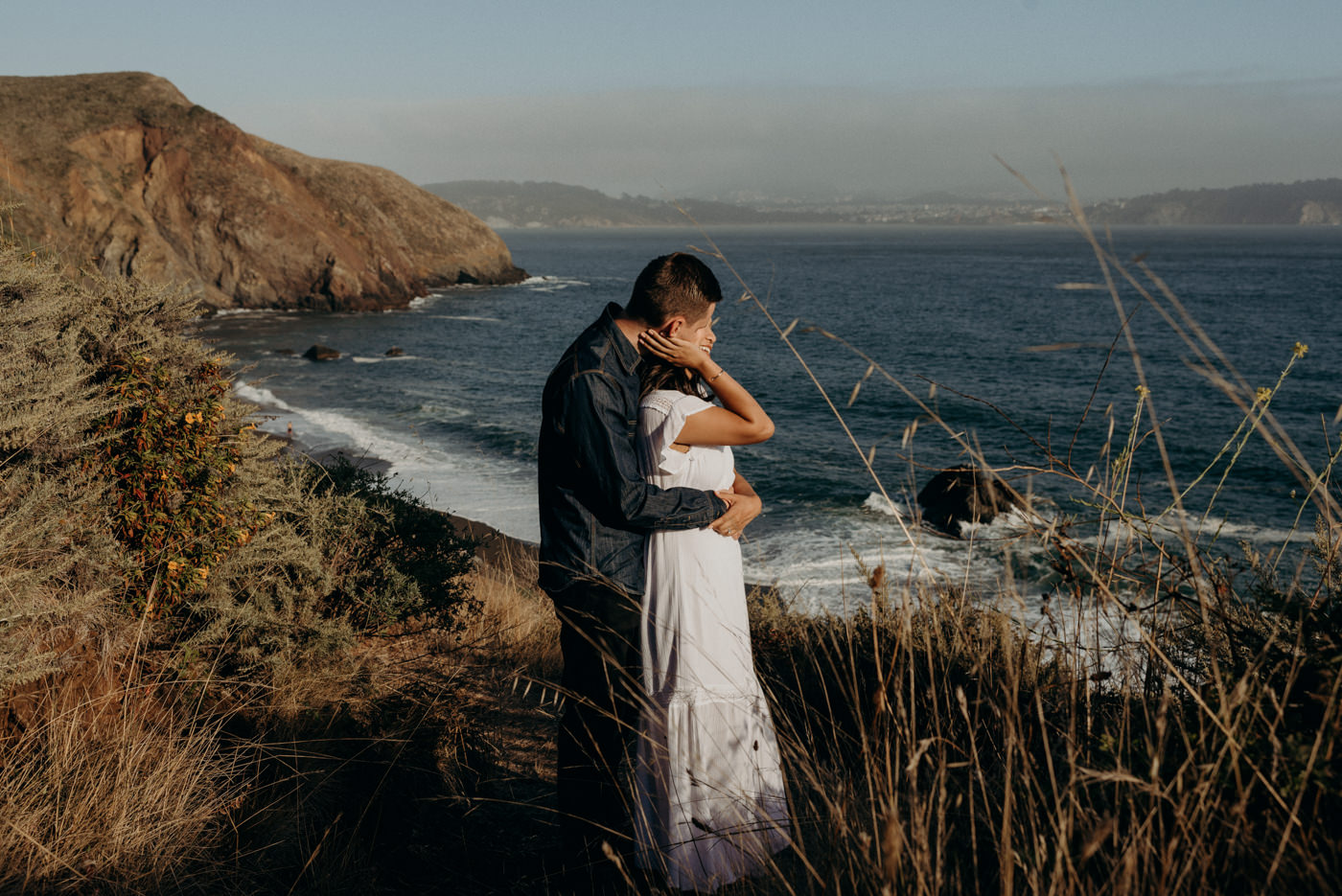 Couple hugging at Marin Headlands at sunset