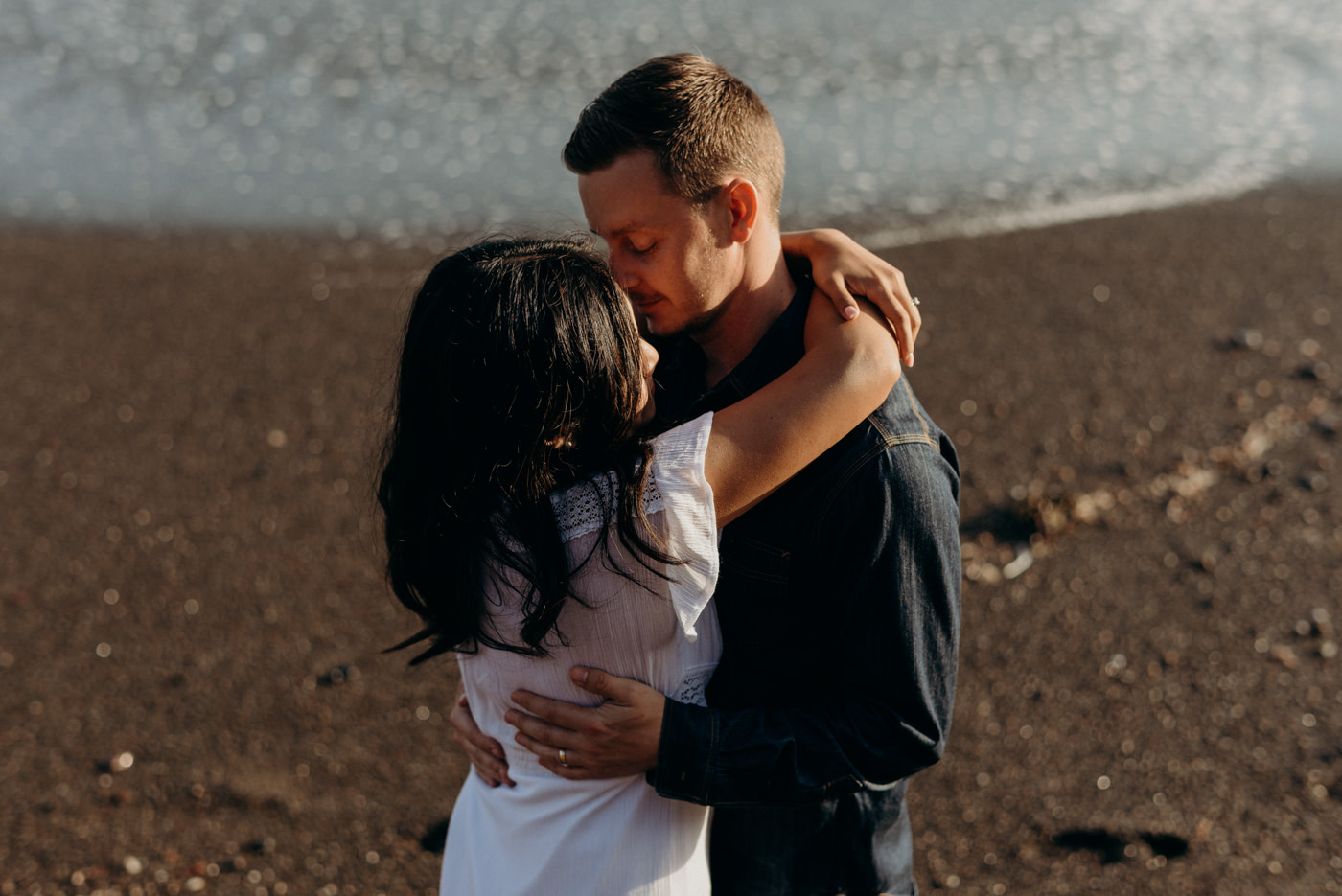 Close up of couple kissing at sunset