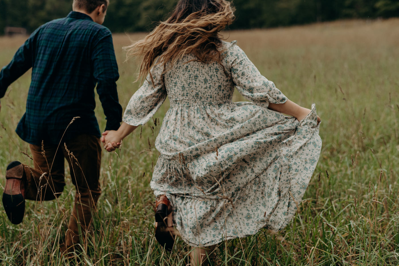 couple running through a field at Whispering Springs