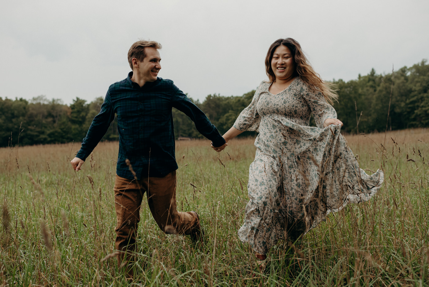 Whispering Springs engagement shoot walking through a field