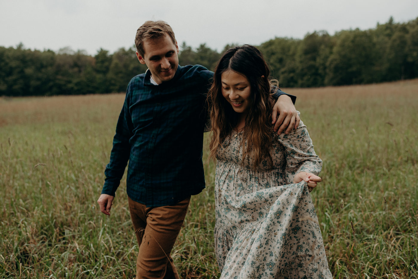 couple running through a field at Whispering Springs