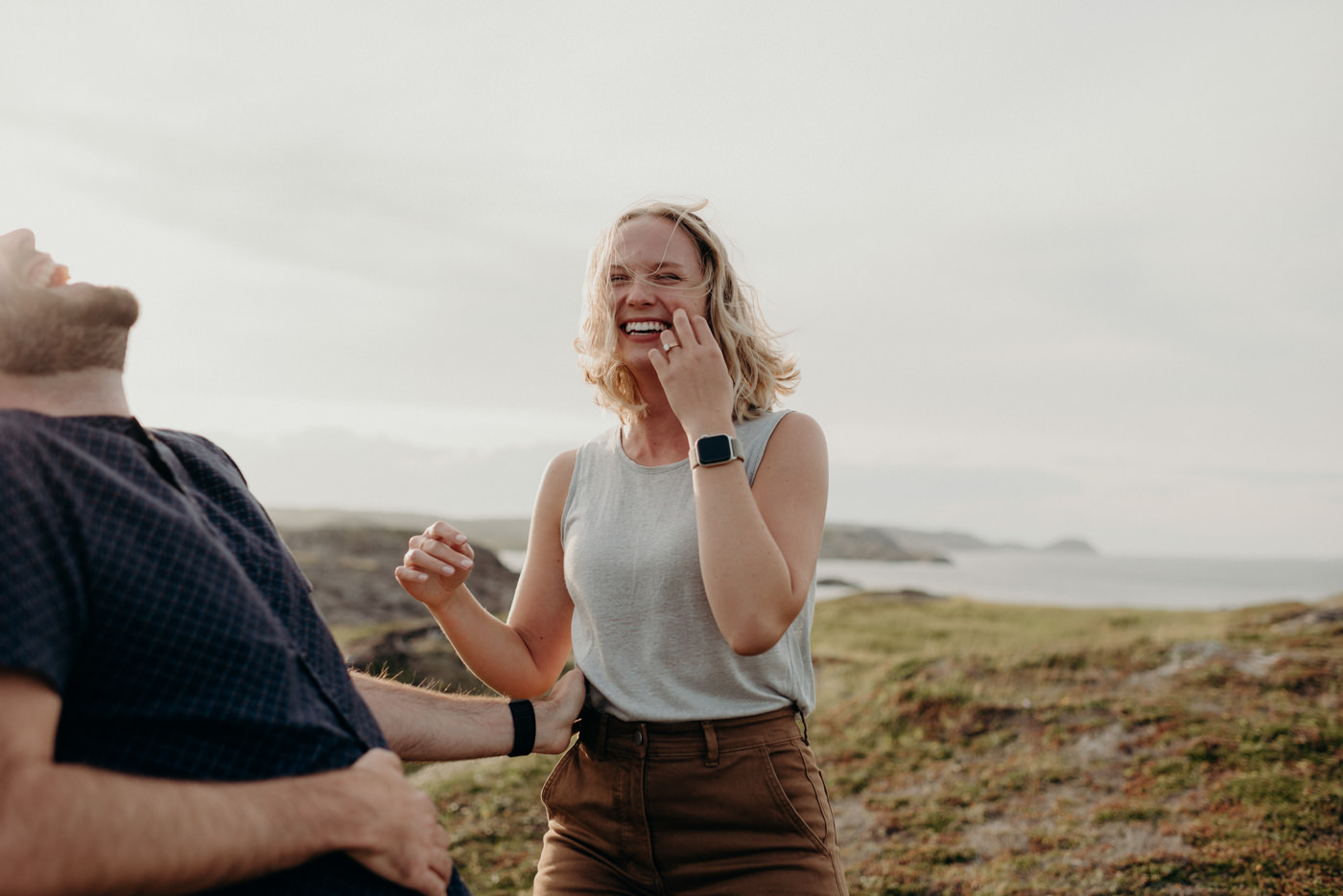 Couple hugging and laughing by the ocean, Fogo island couple shoot