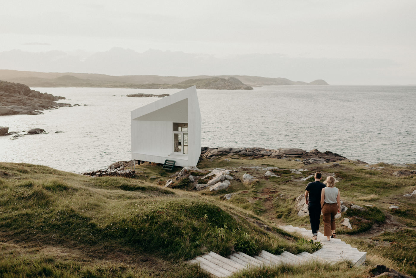 Couple walking on path to Squish Studio on Fogo Island