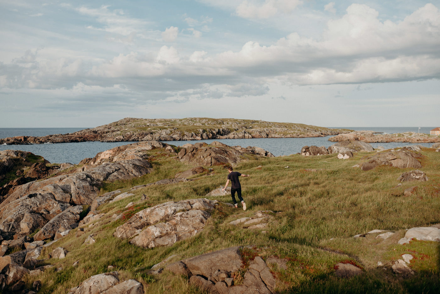 Guy running on rocks on fogo island