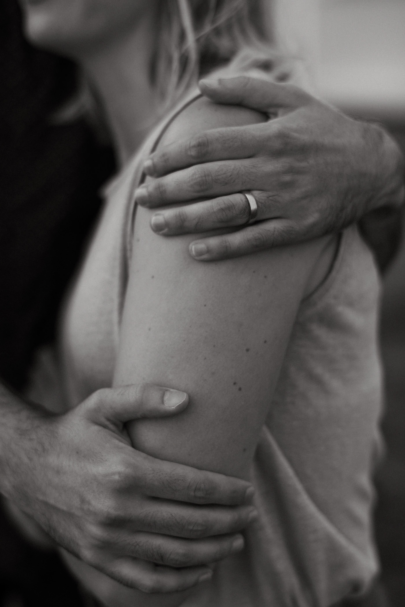 black and white images of husbands hands on wifes arm