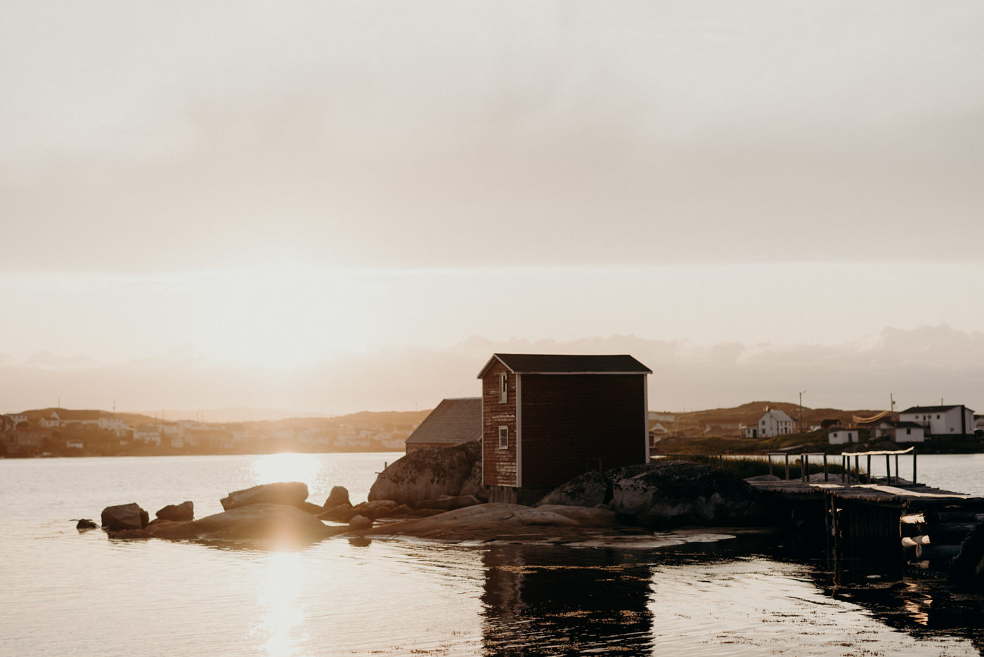 Sunset on harbour with fish shed in background in Tilting, Fogo Island