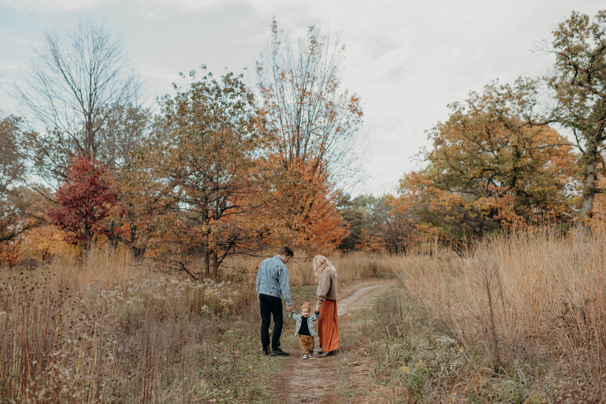 Young family in High Park during fall colours