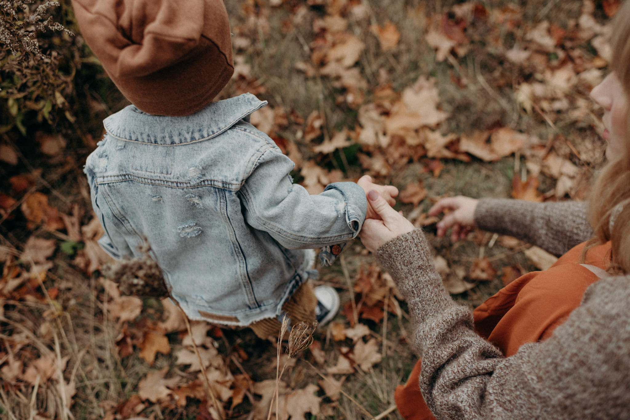 Mother holding sons hand