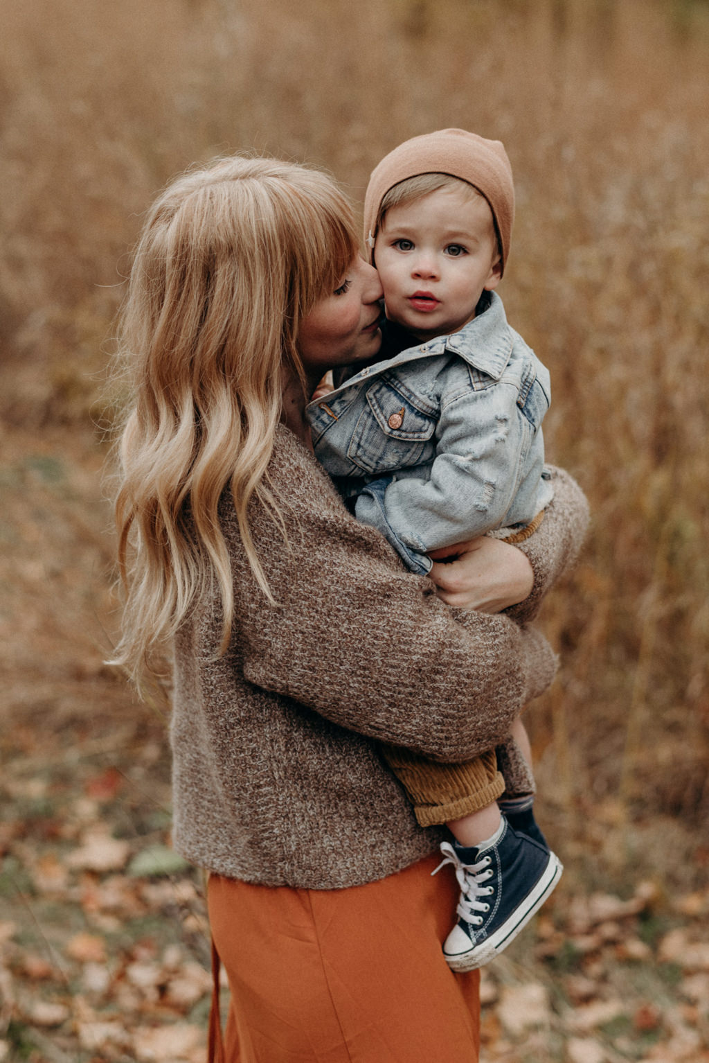 Mother hugging toddler son, fall portraits