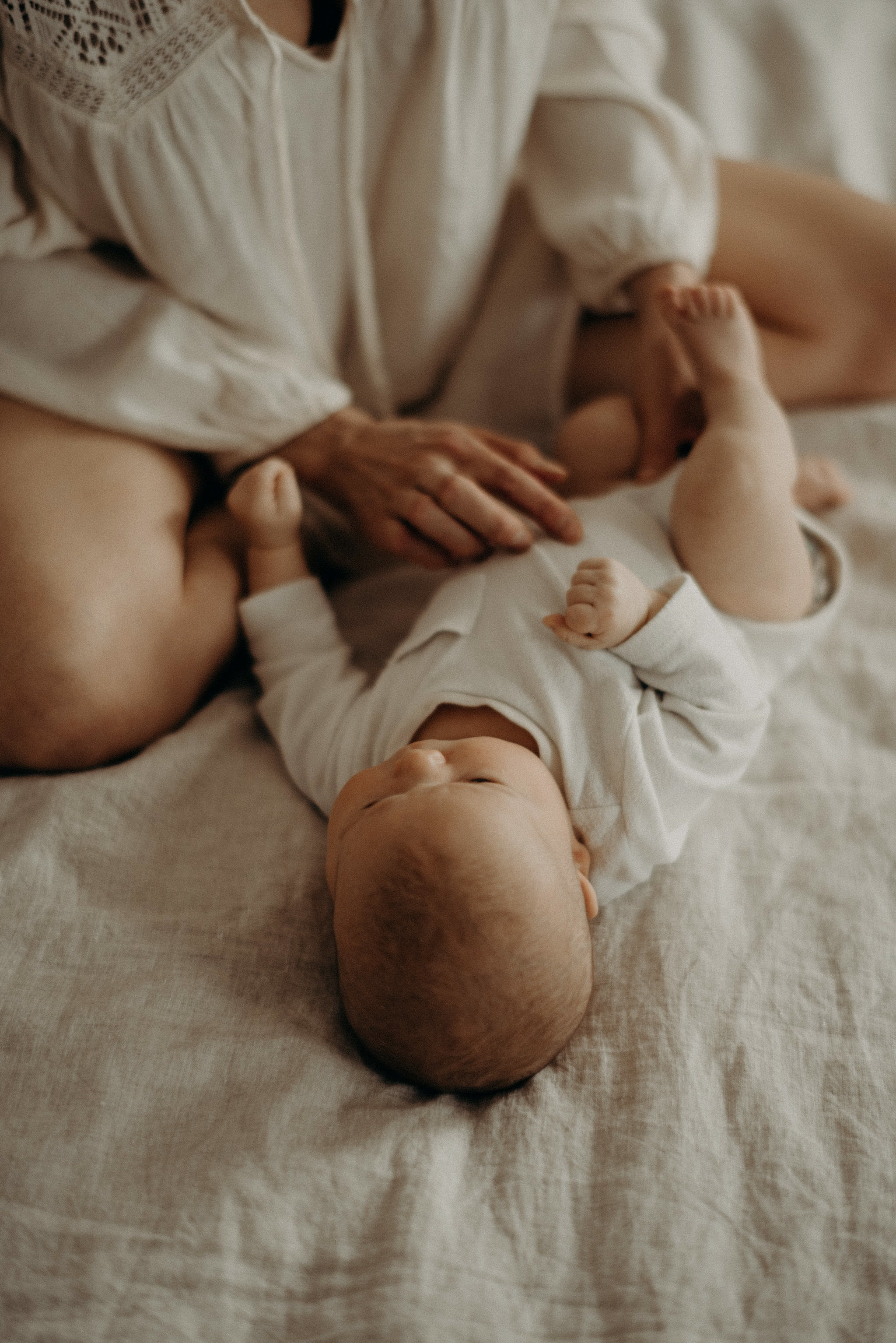 mother and newborn baby on the bed