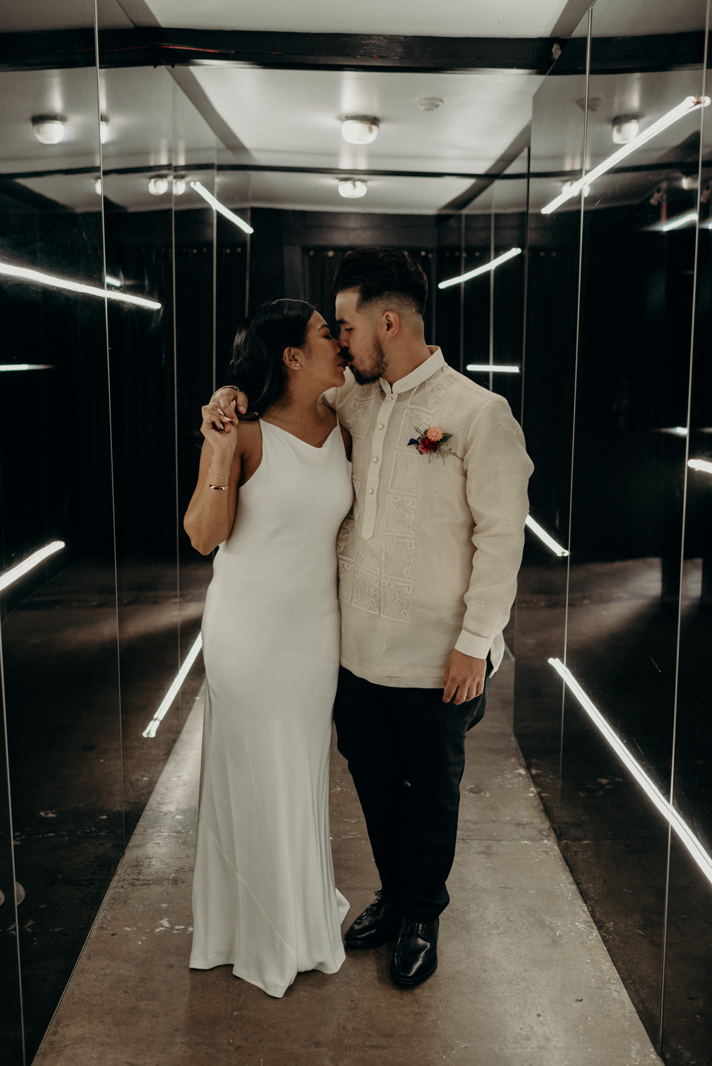 Bride and groom portraits walking down lit hallway at Airship37