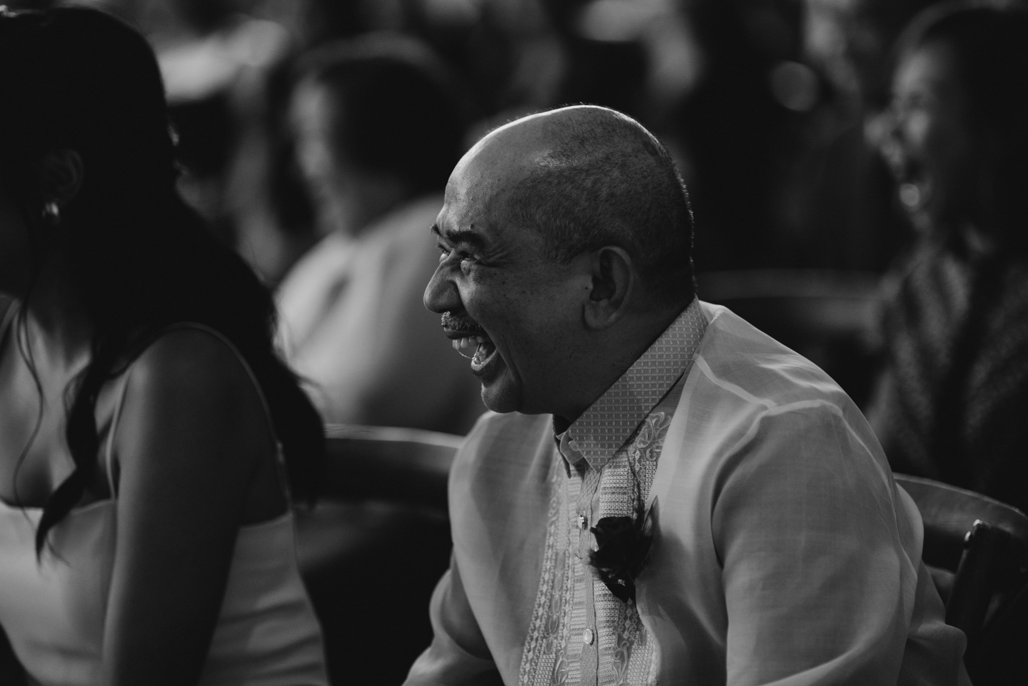father of the bride laughing during wedding ceremony