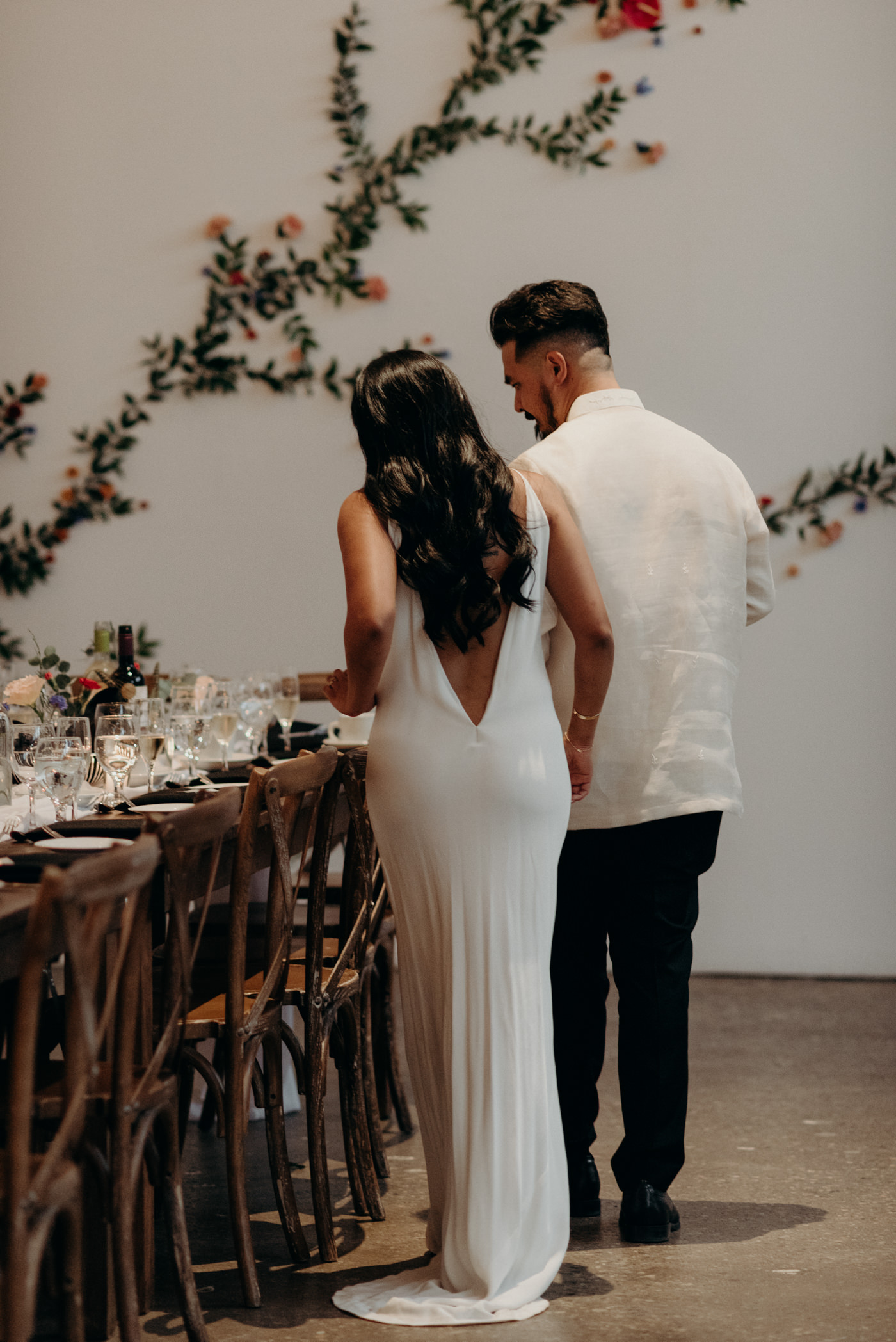 bride and groom checking out the table setting at wedding reception