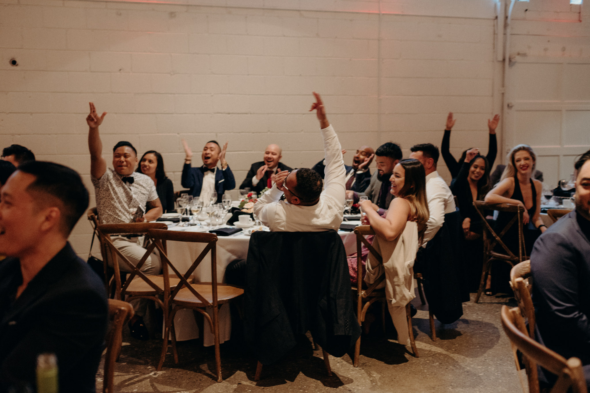 Guests cheering at wedding reception