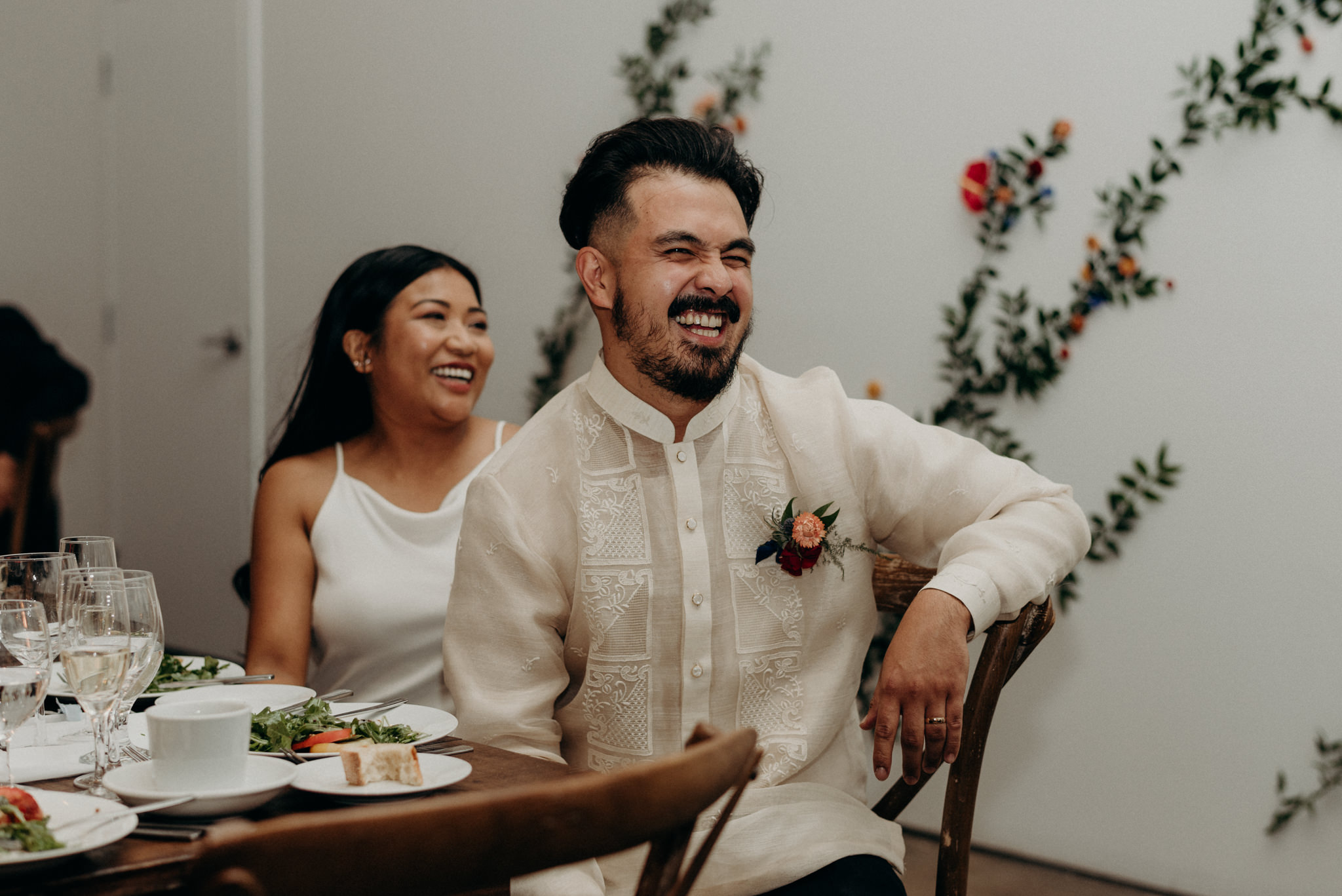 Groom laughing during speech