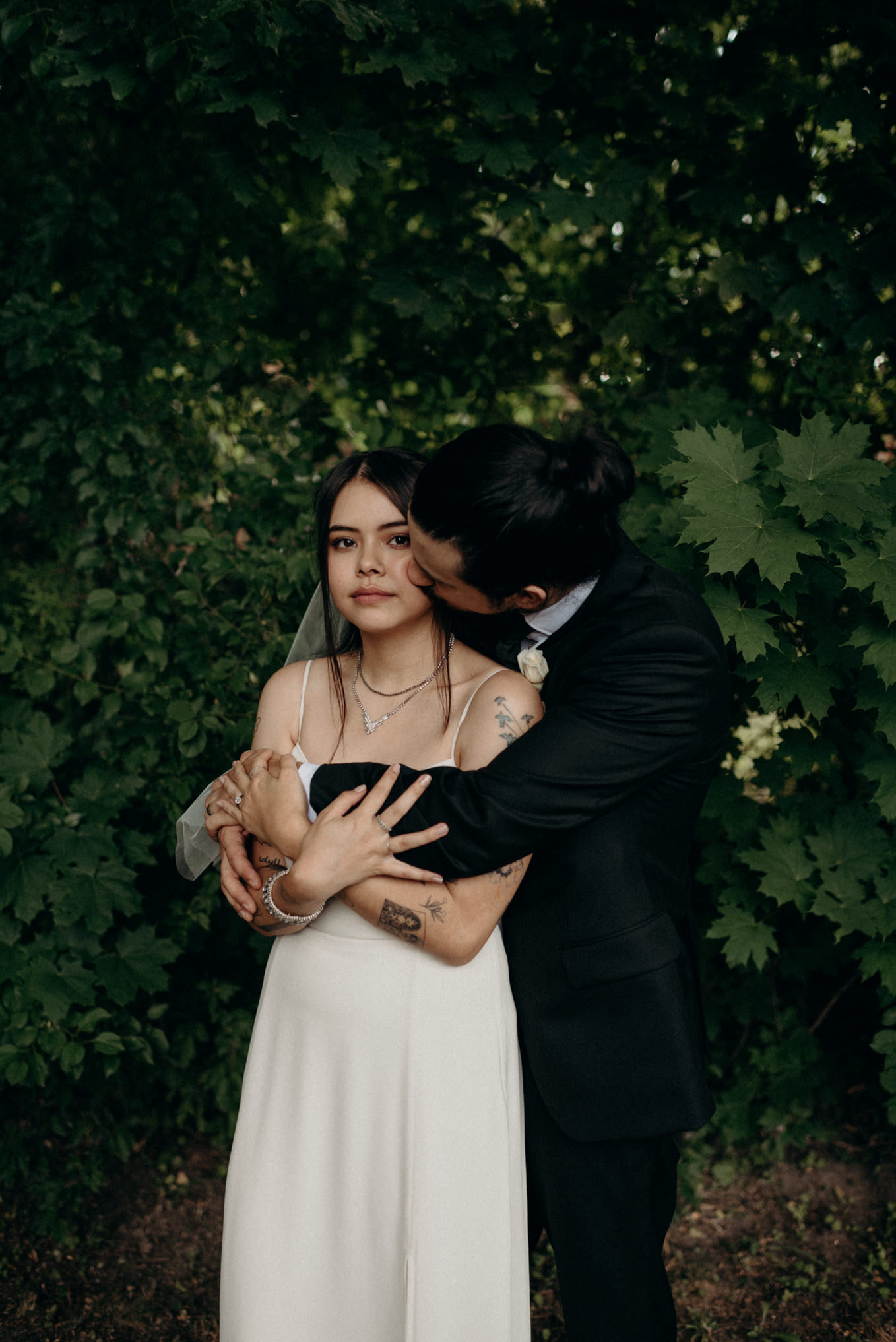 groom kissing bride on cheek