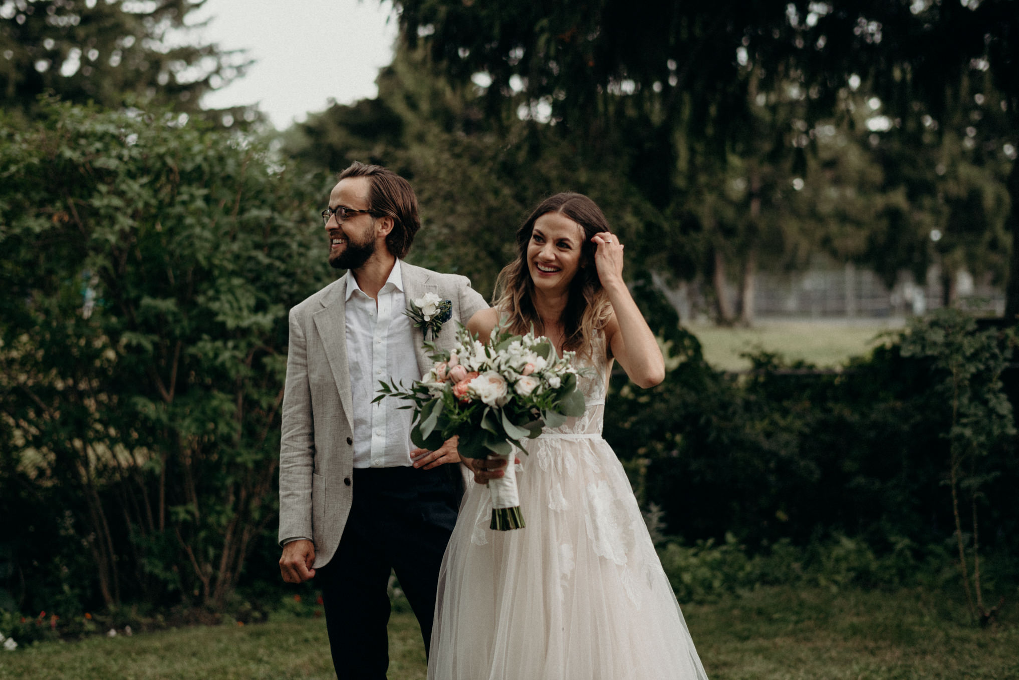 bride and groom smiling in backyard