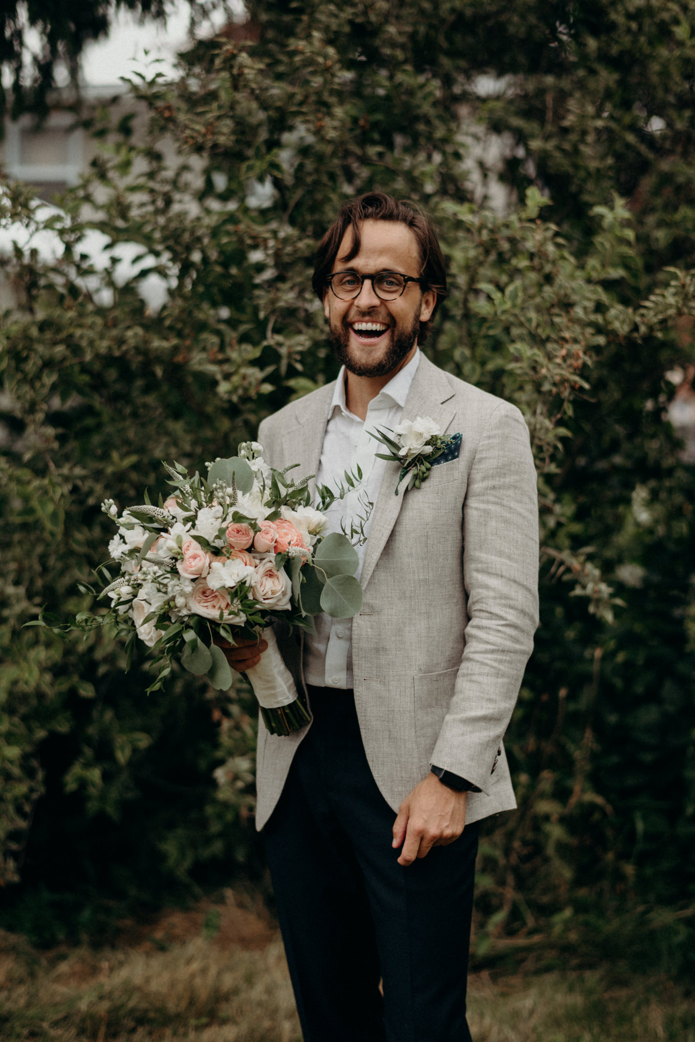 groom holding bouquet