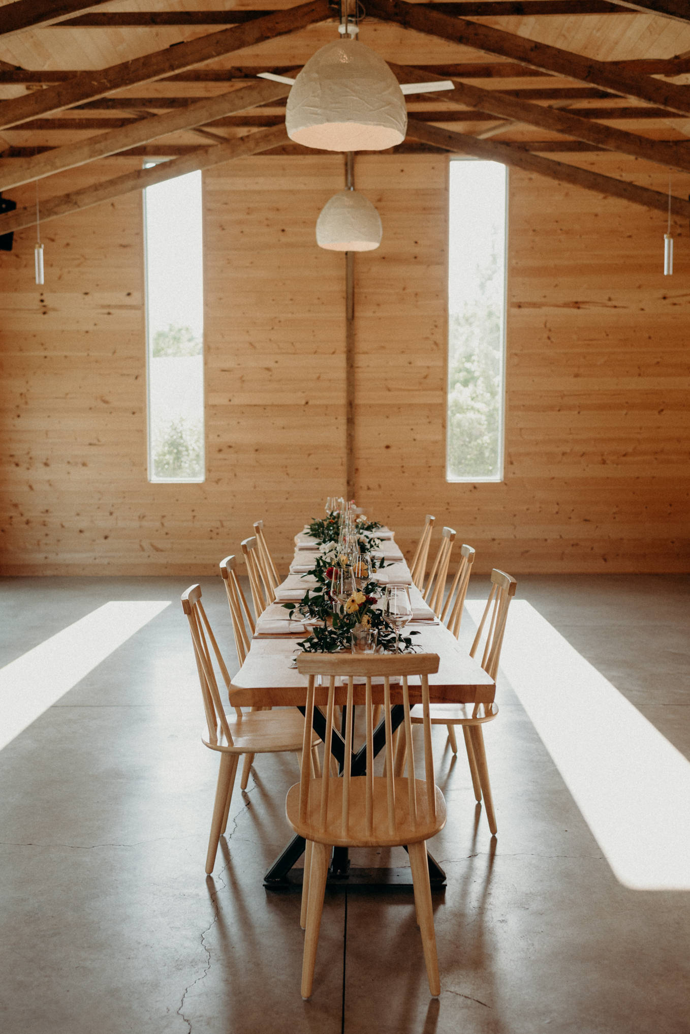 micro wedding dinner setup inside modern wooden barn at 100 acre wood wedding