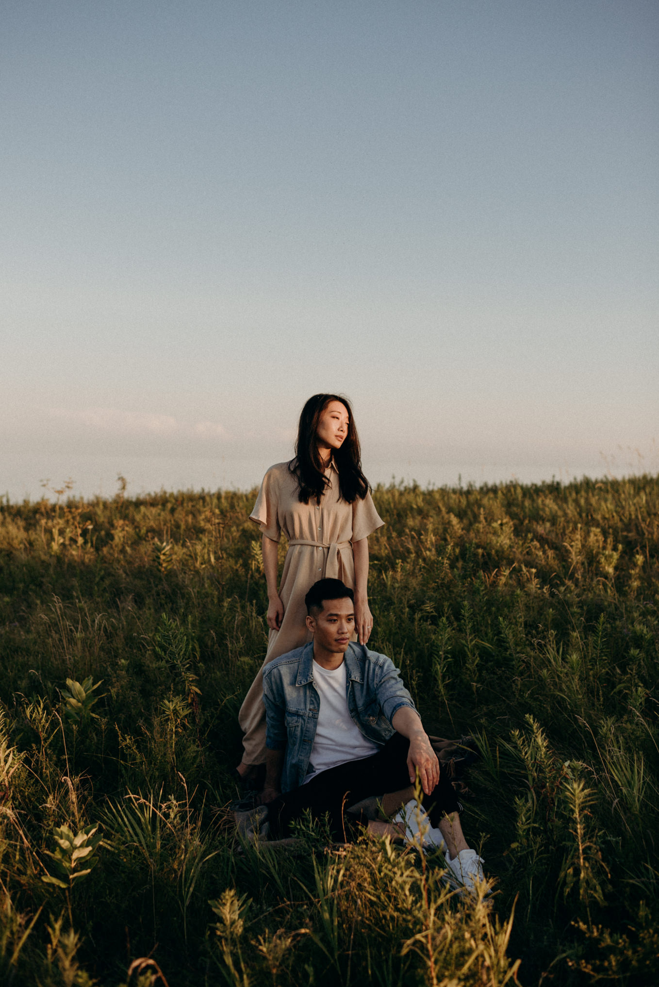 Couple standing in overgrown grass