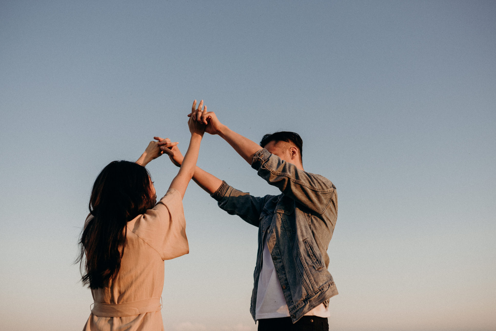 Couple holding hands in the air