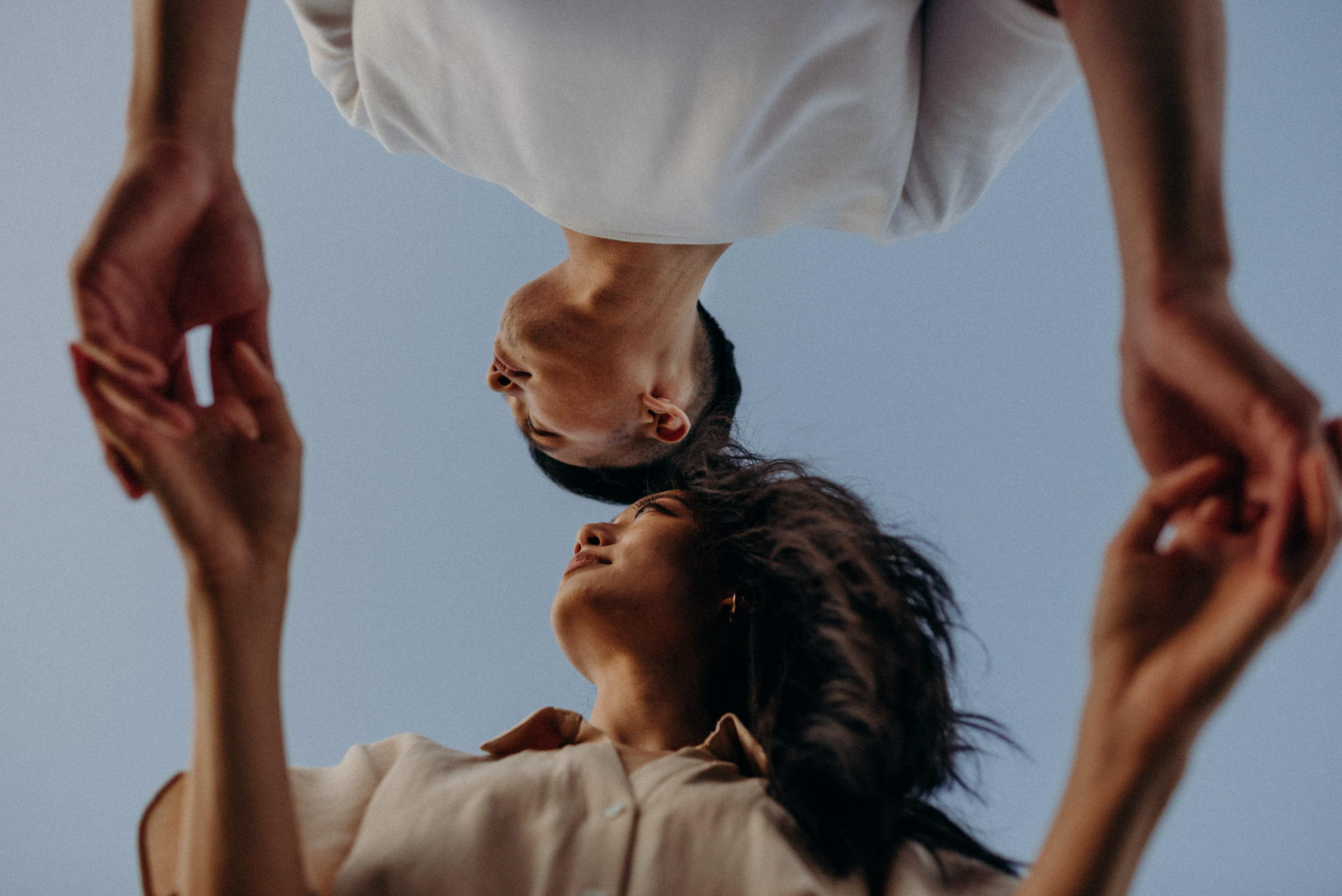 Cool perspective shot of couple leaning over photographer