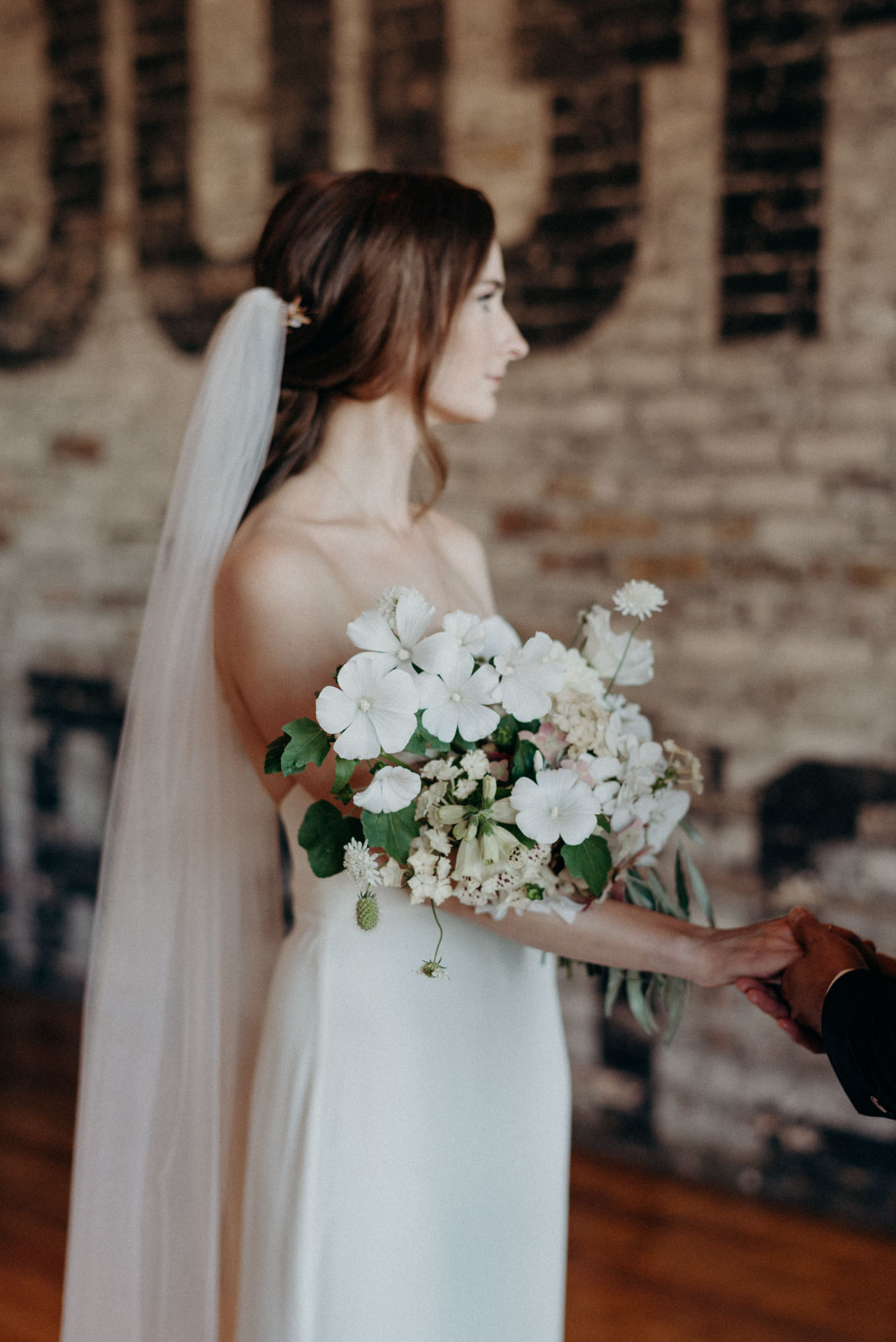 bride and groom holding hands during ceremony